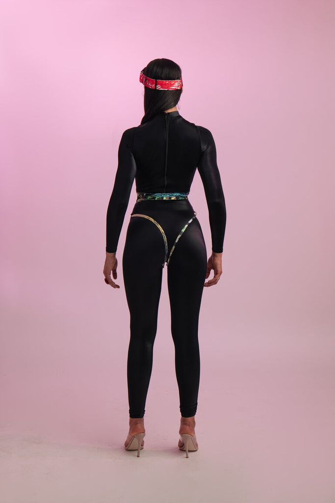 Shiny black catsuit with a colorful string looped around the waist and things