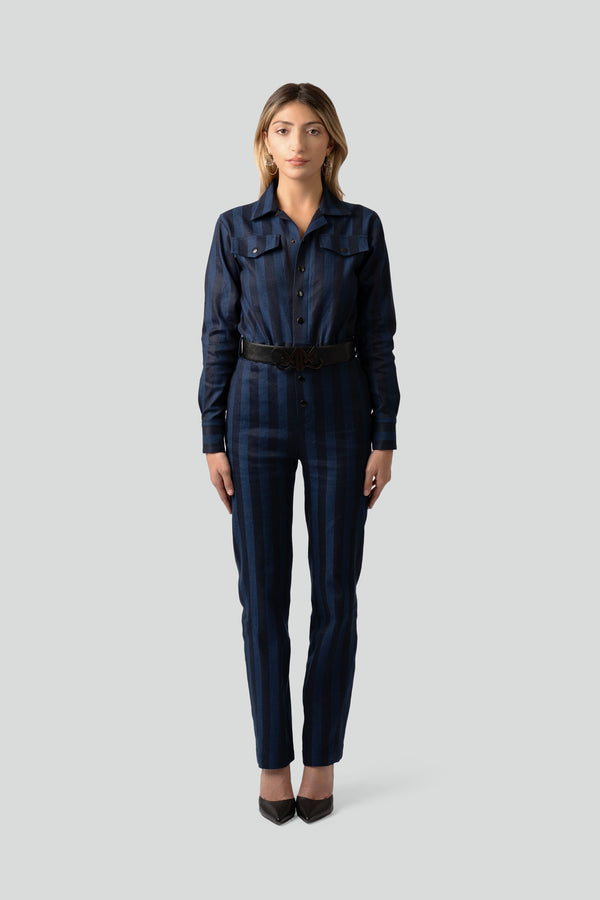 Model styling a luxury navy blue vertical stripe one piece pantsuit in a sophisticated office to evening outfit