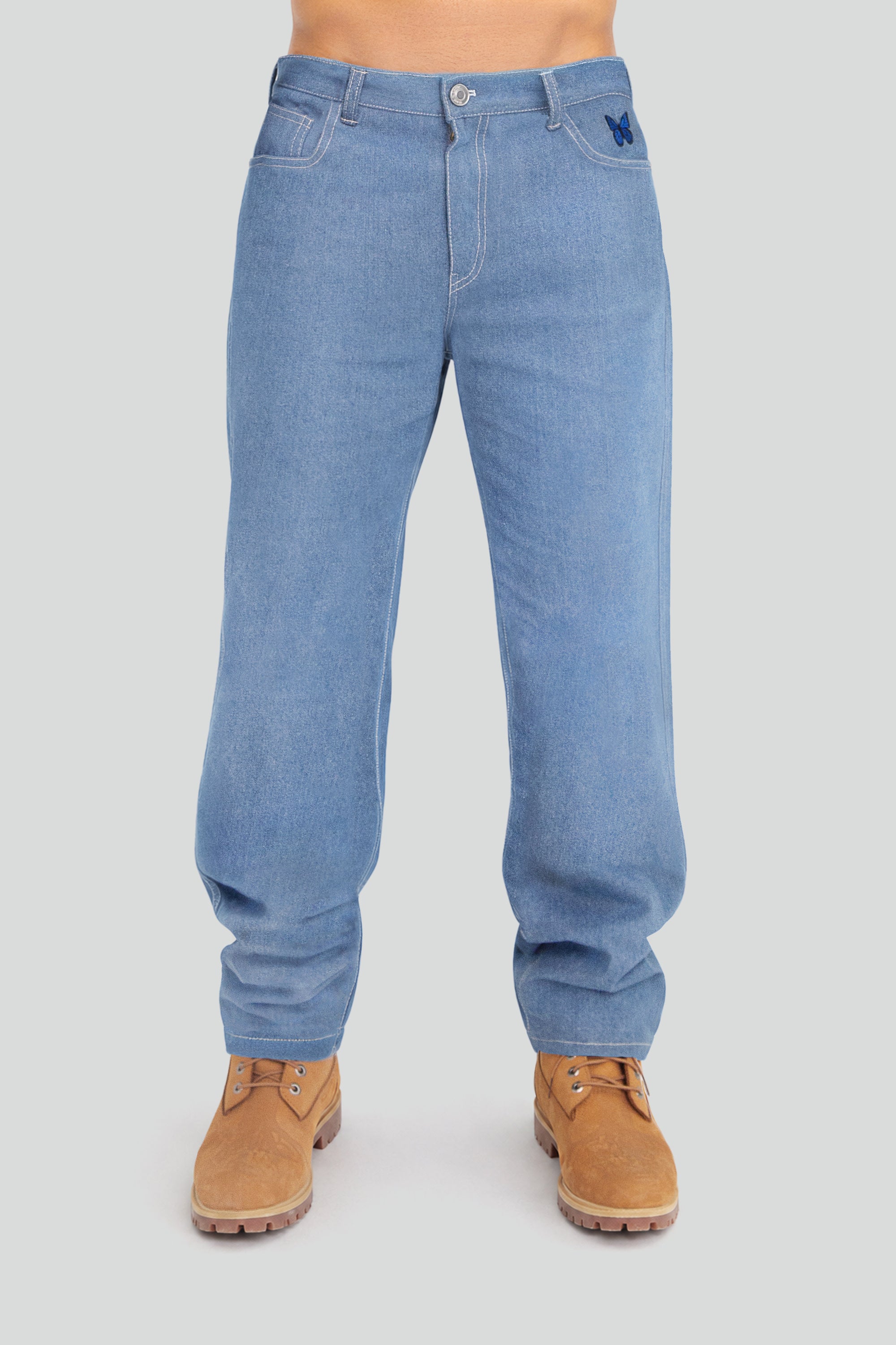 Blue jeans worn by a person on a gray background