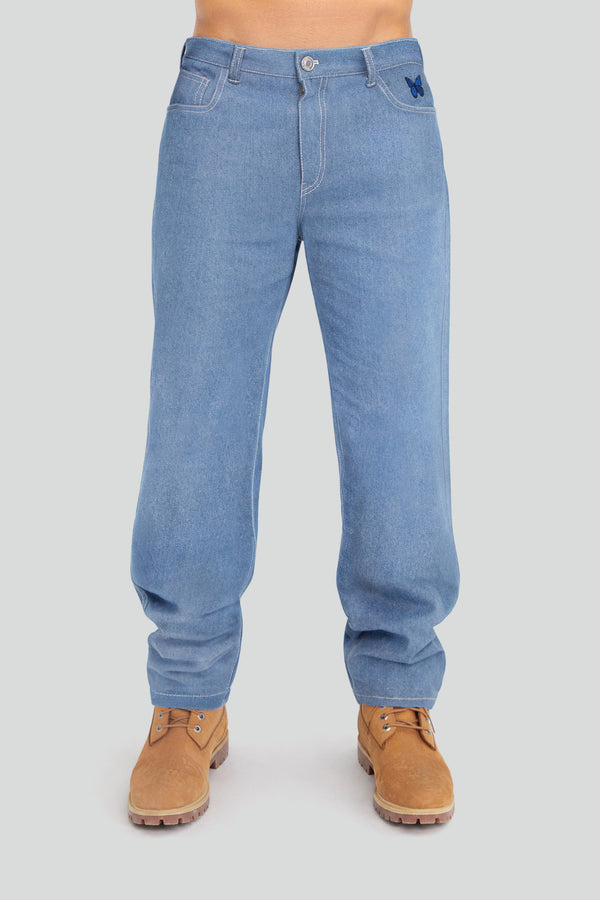 Man wearing light wash straight leg denim jeans with subtle pocket embroidery