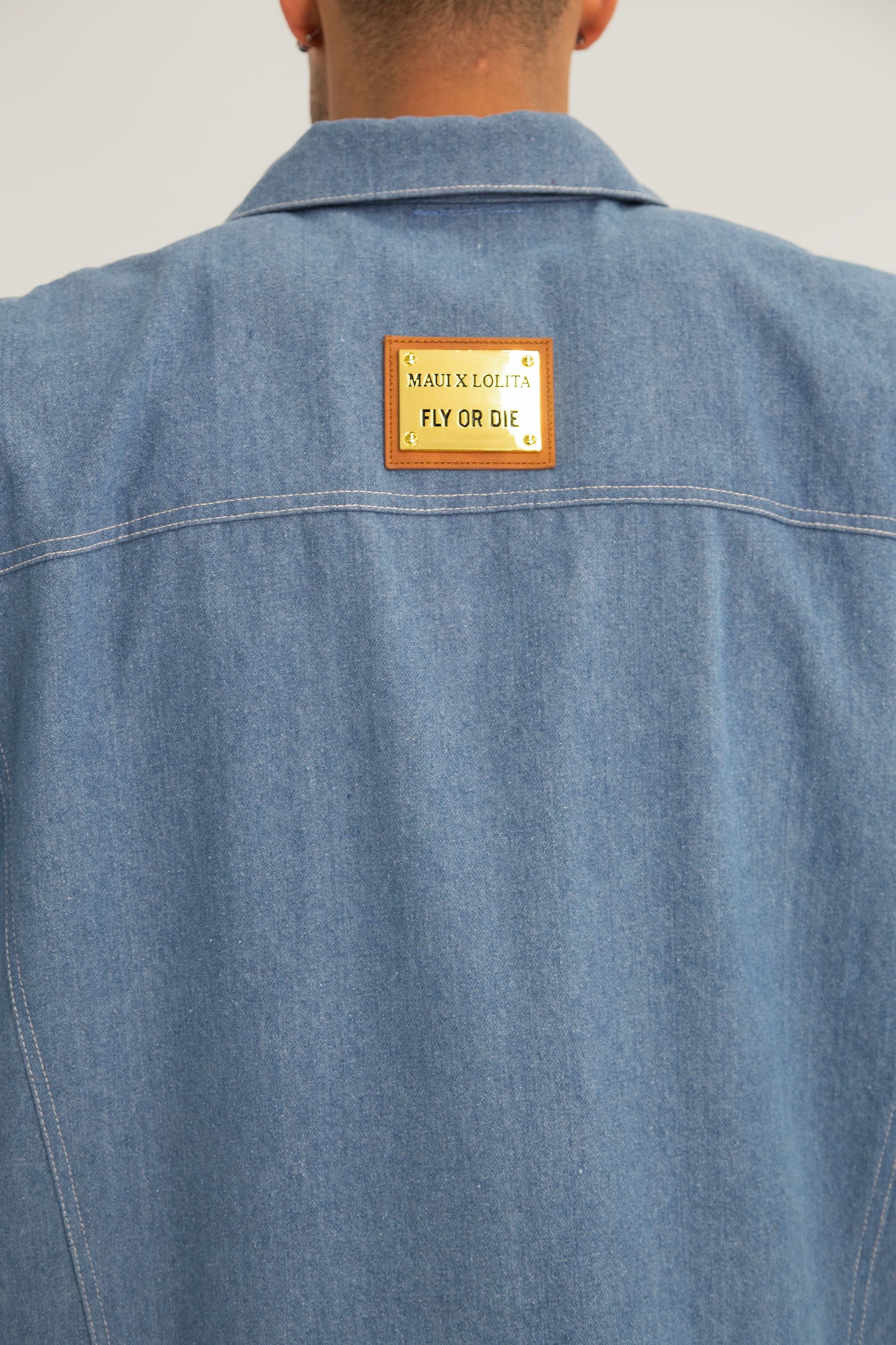 Blue denim jacket with a patch on the back