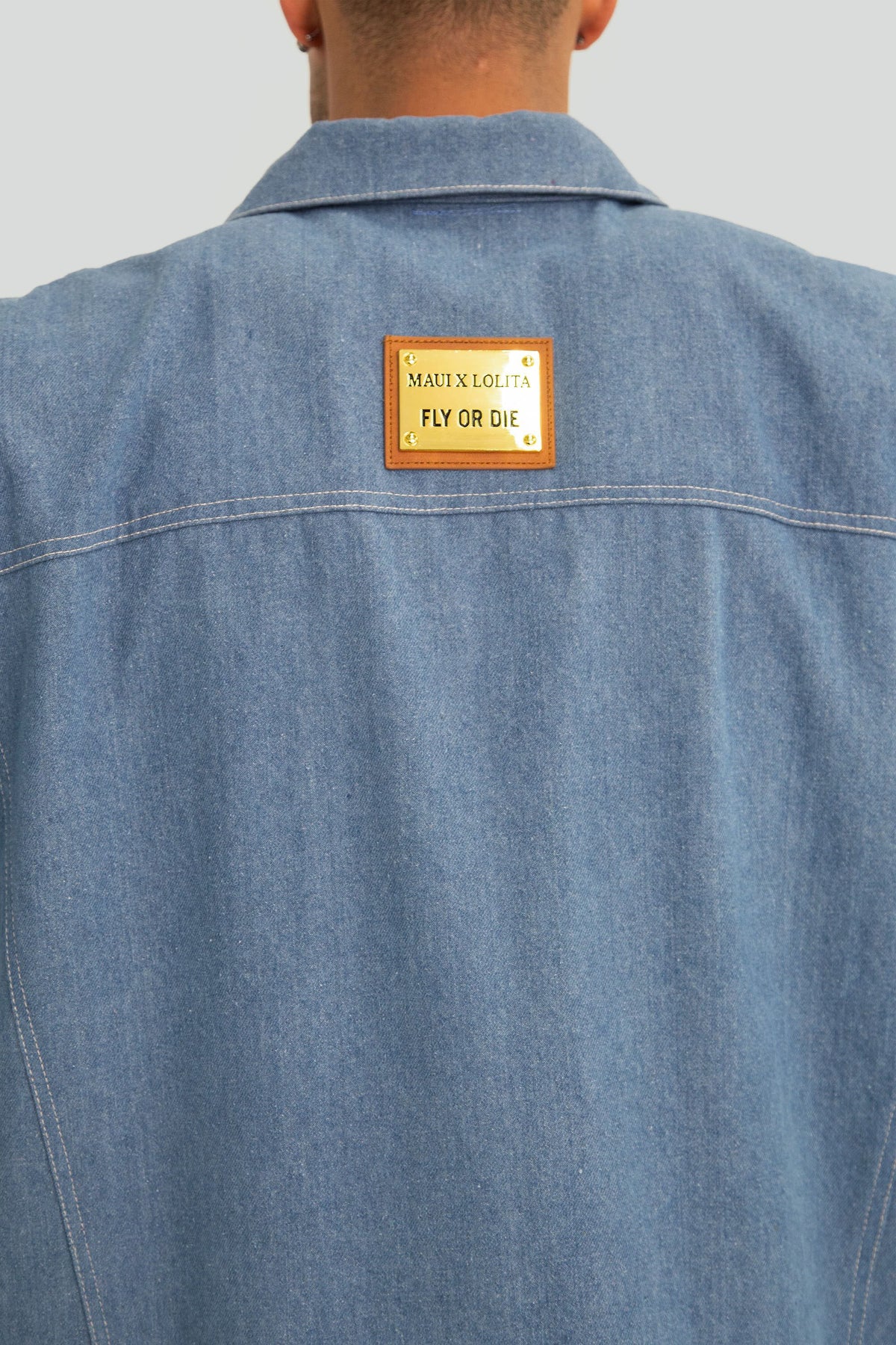 Blue denim jacket with brand label on the back