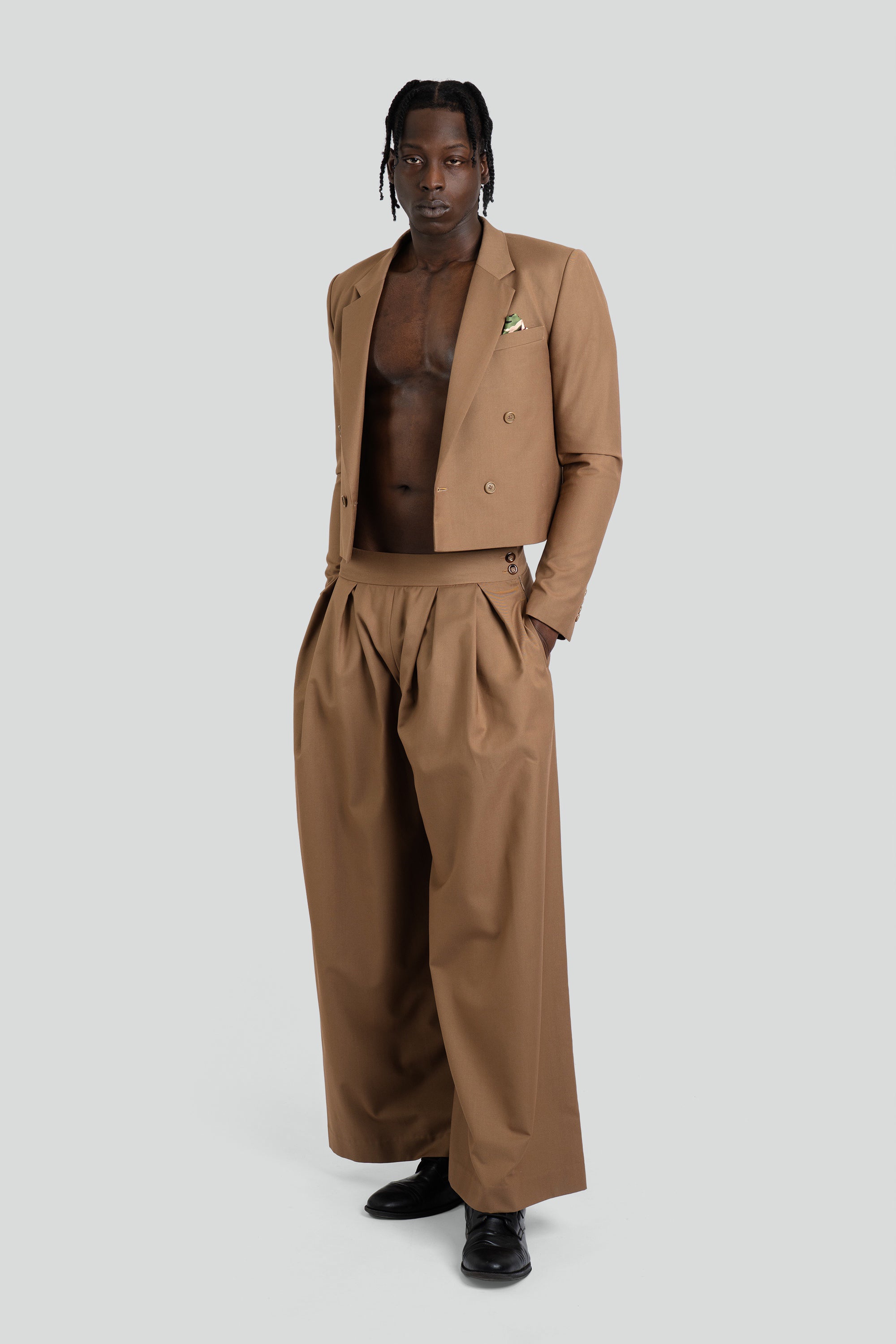 Man wearing a brown suit with a white background