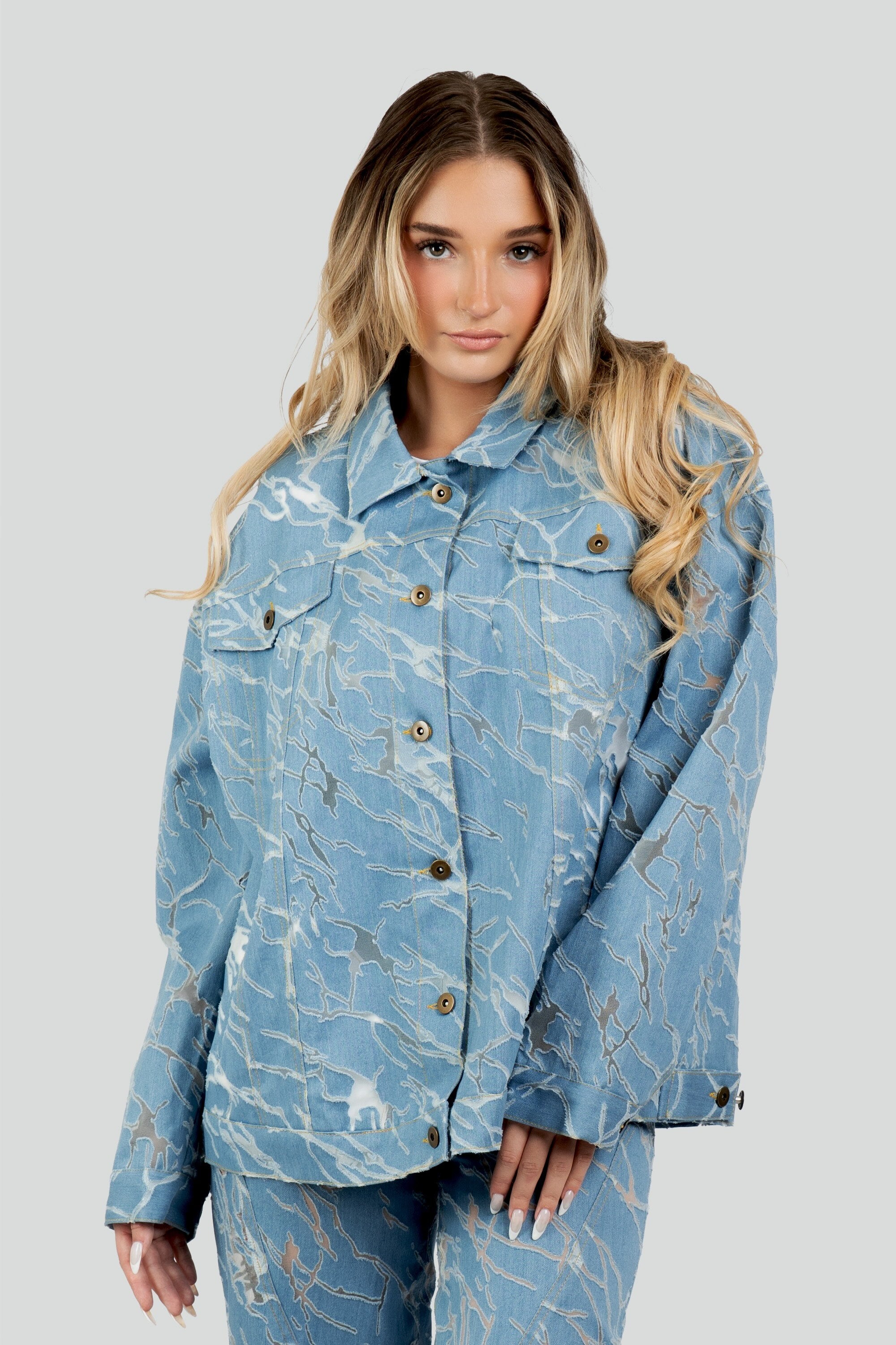 Structured oversized jacket featuring a semi-sheer mesh body with a marbled blue pattern, traditional denim collar, and metallic button-front closure