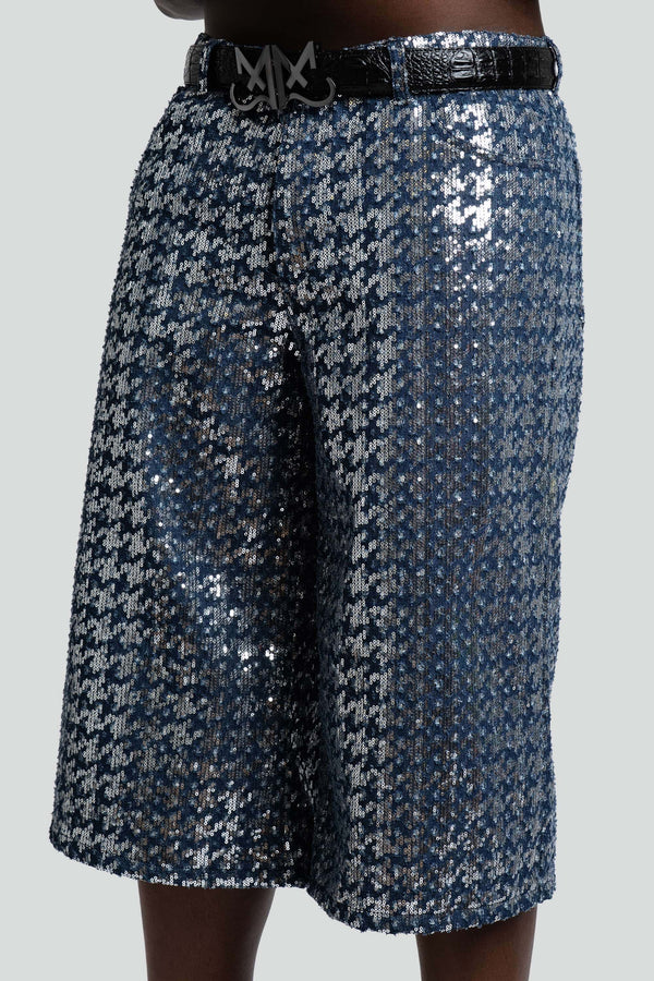 Close-up detail of the shimmering blue sequins stitched over classic blue denim fabric on the Maui X Lolita Bleu Sparked collection