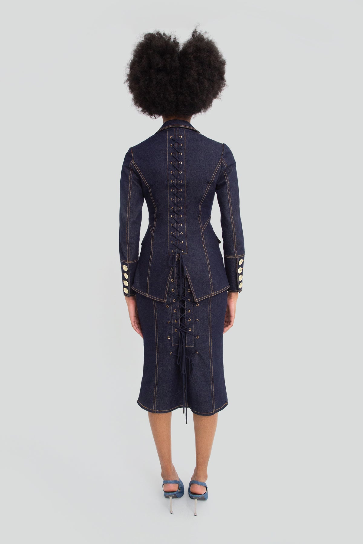 Woman wearing a dark wash indigo denim corset shirt and matching high waisted denim pencil skirt co ord set