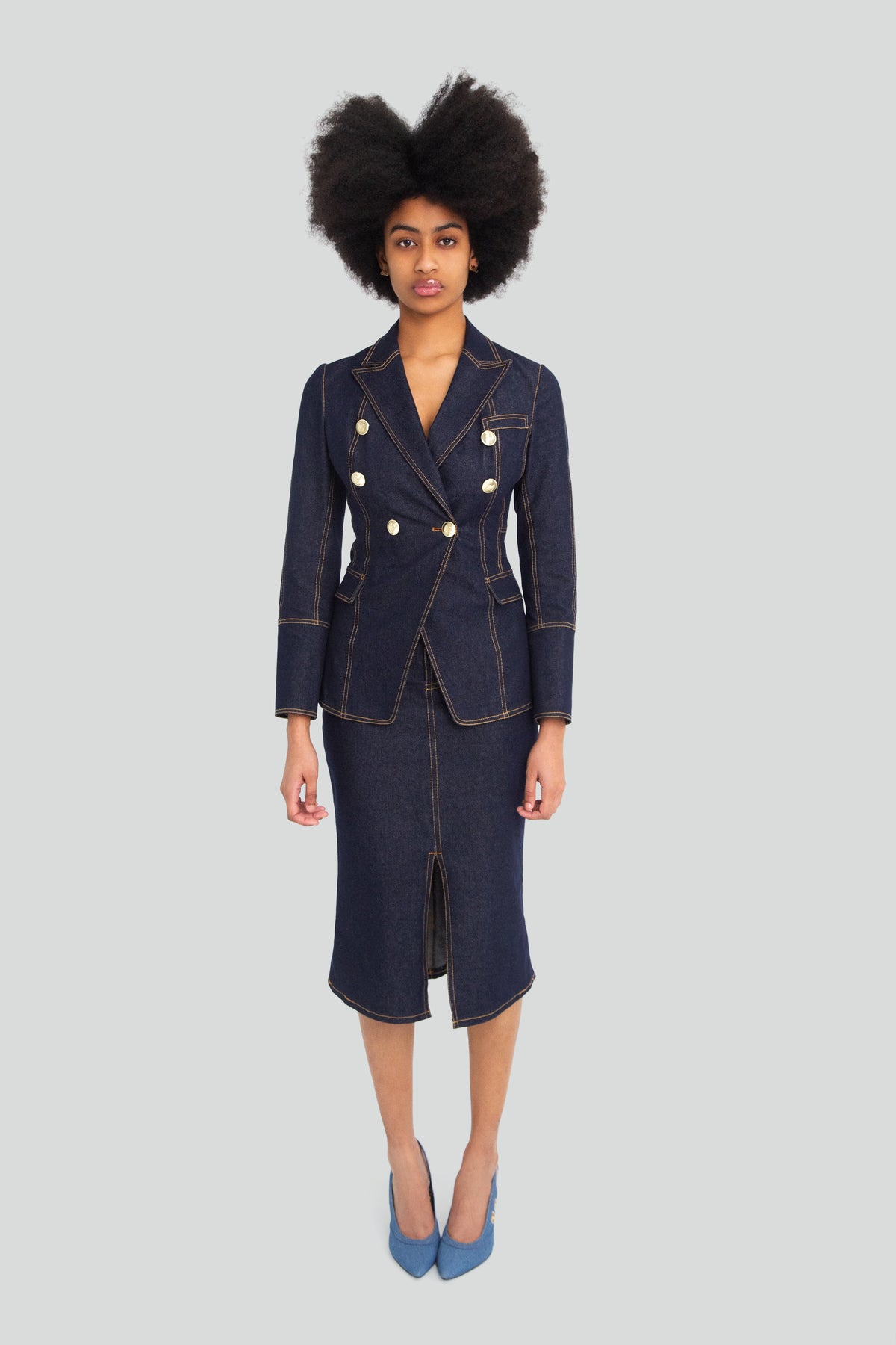 Woman wearing a dark wash indigo denim corset shirt and matching high waisted denim pencil skirt co ord set
