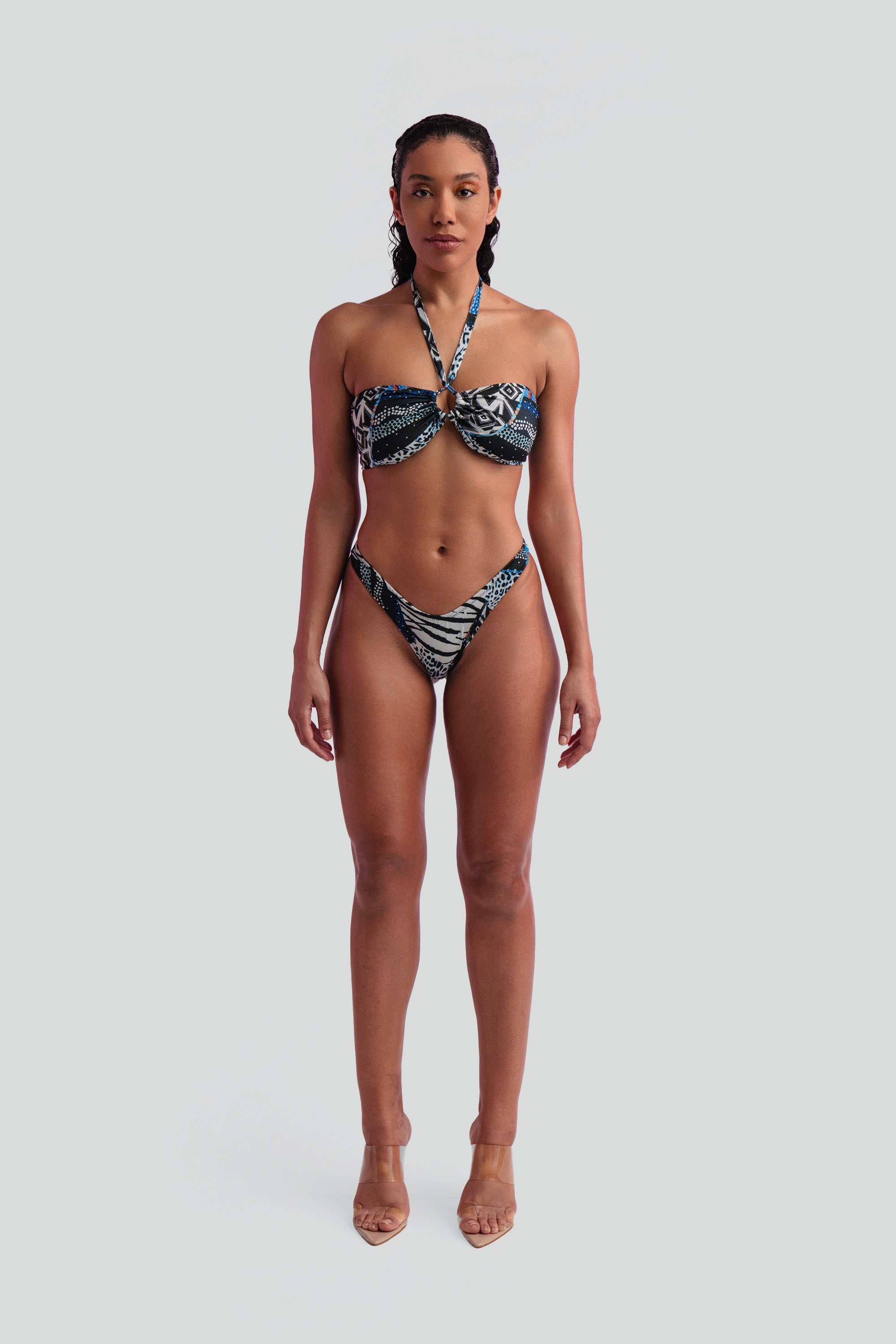 Woman wearing a patterned bikini set against a plain background