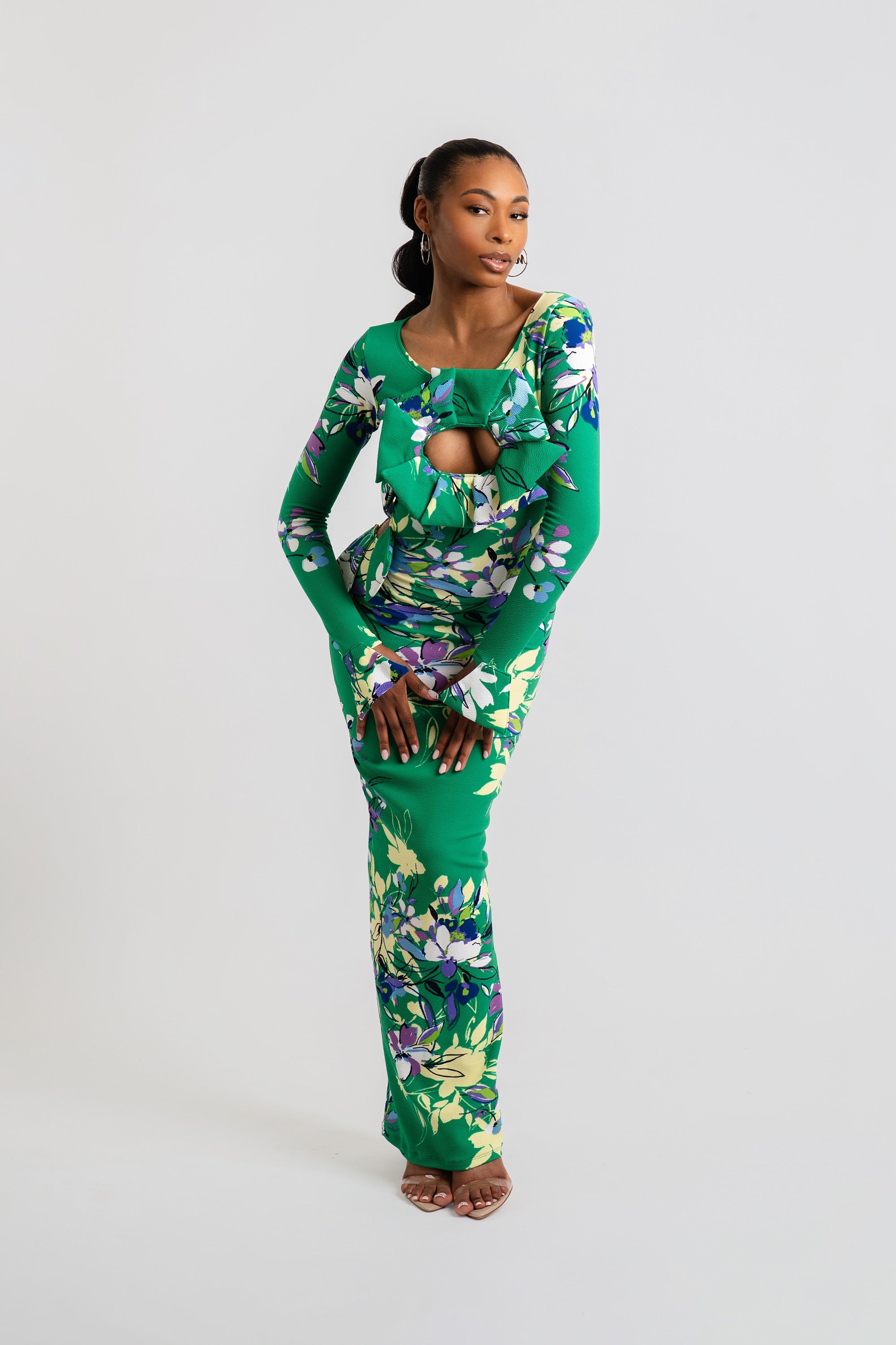 Woman wearing a green floral dress on a white background