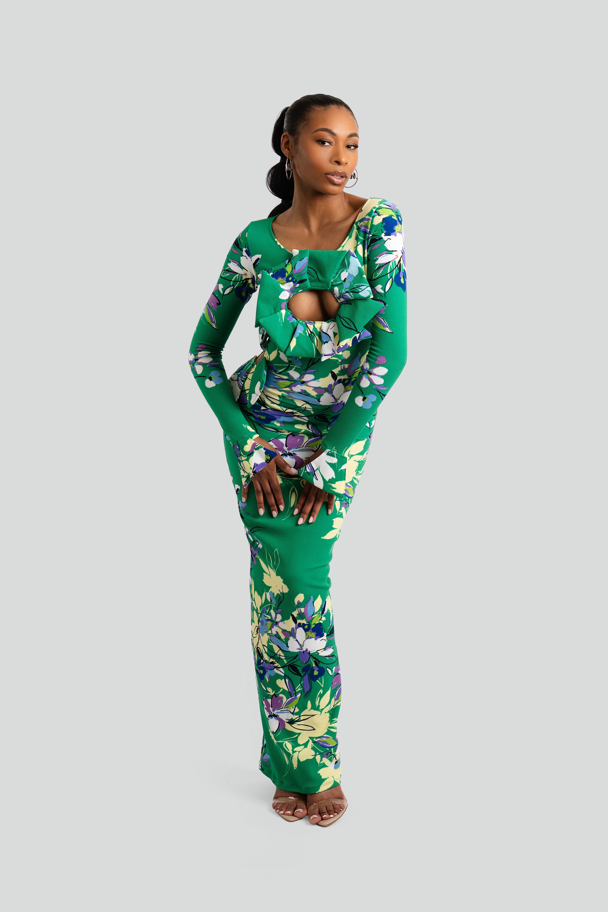 Woman wearing a green floral dress on a white background