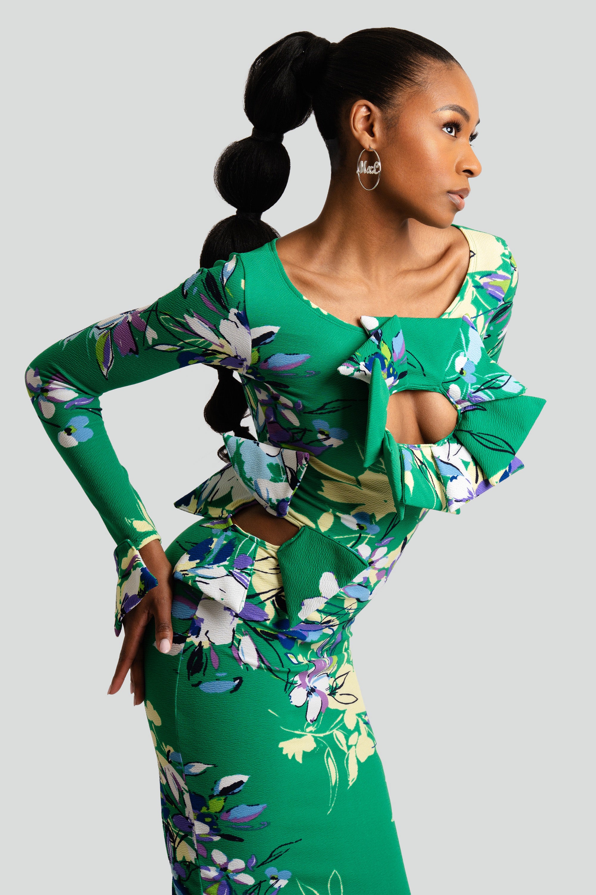 Woman wearing a green floral dress against a white background