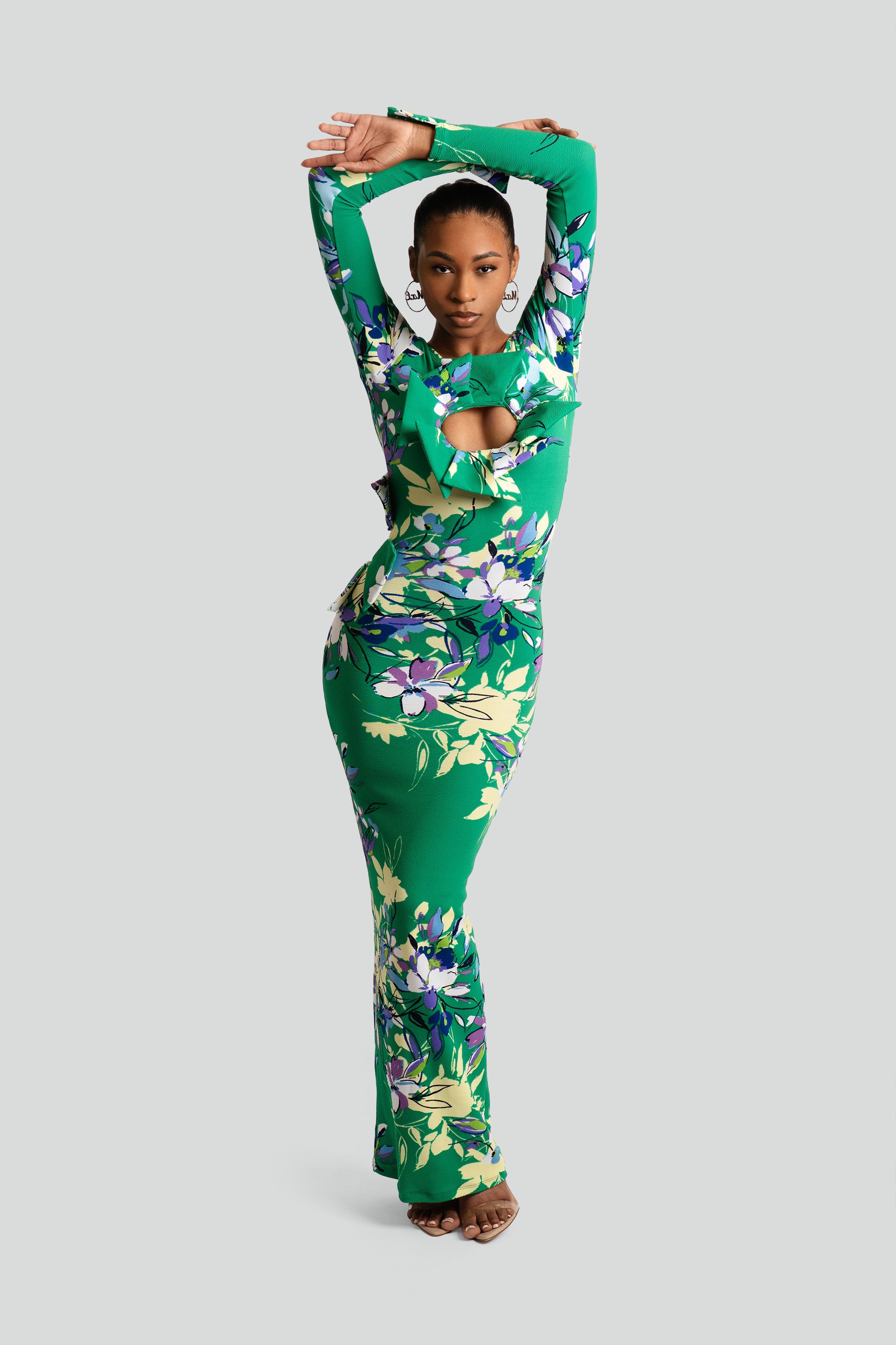 Woman wearing a green floral outfit on a white background