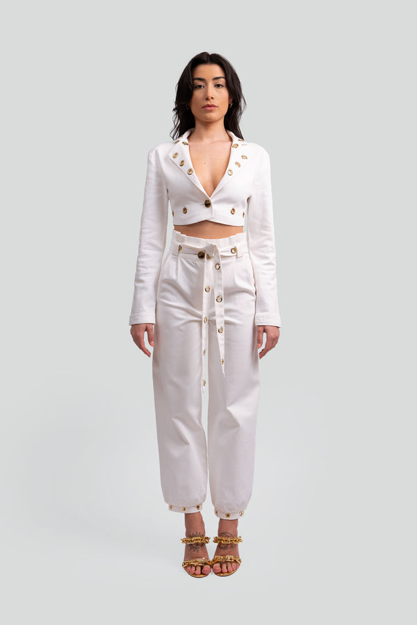 Woman wearing an Elvadira matching set featuring a tailored sleeveless crop top and a flowing high waisted skirt