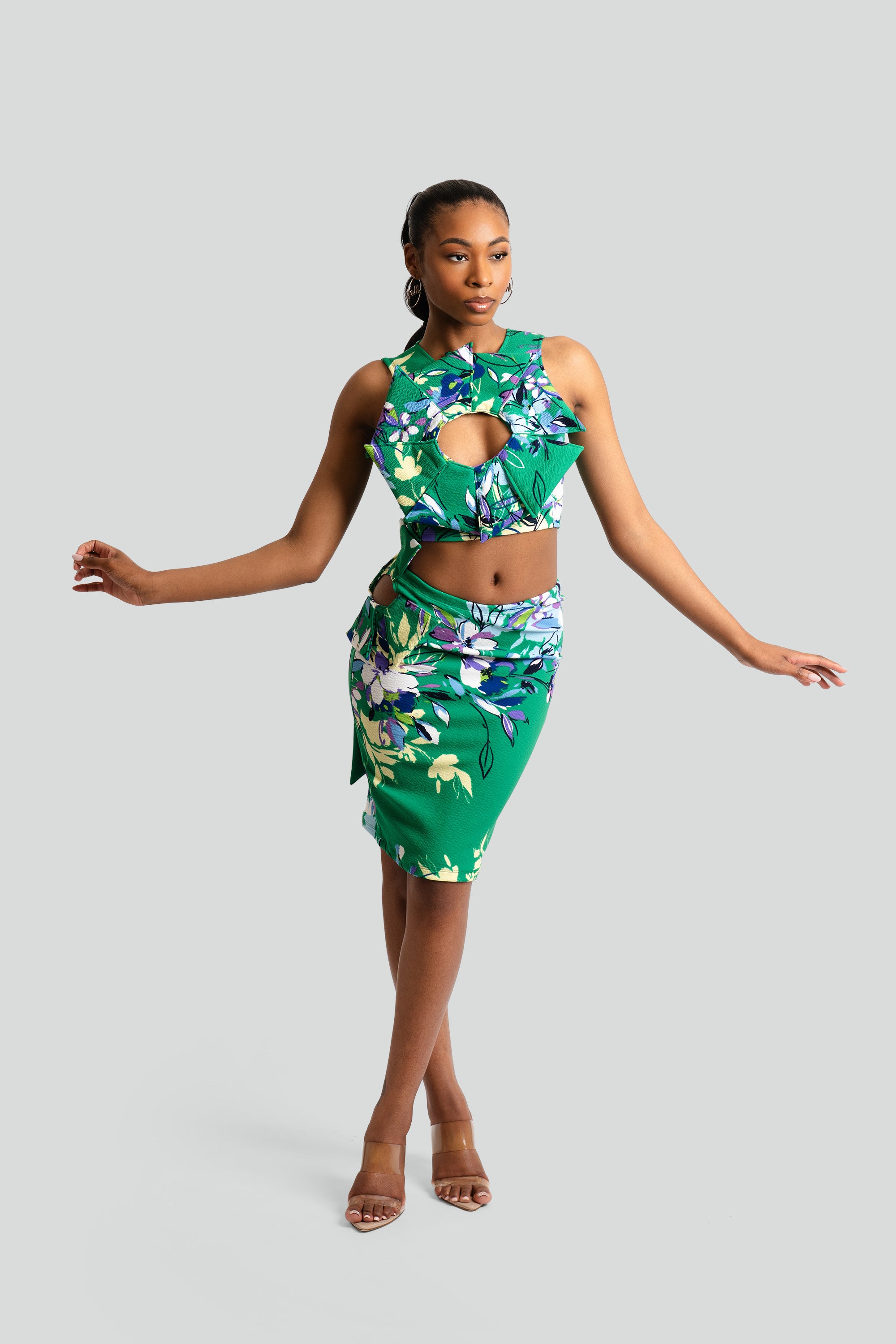 Woman wearing a green floral dress against a white background