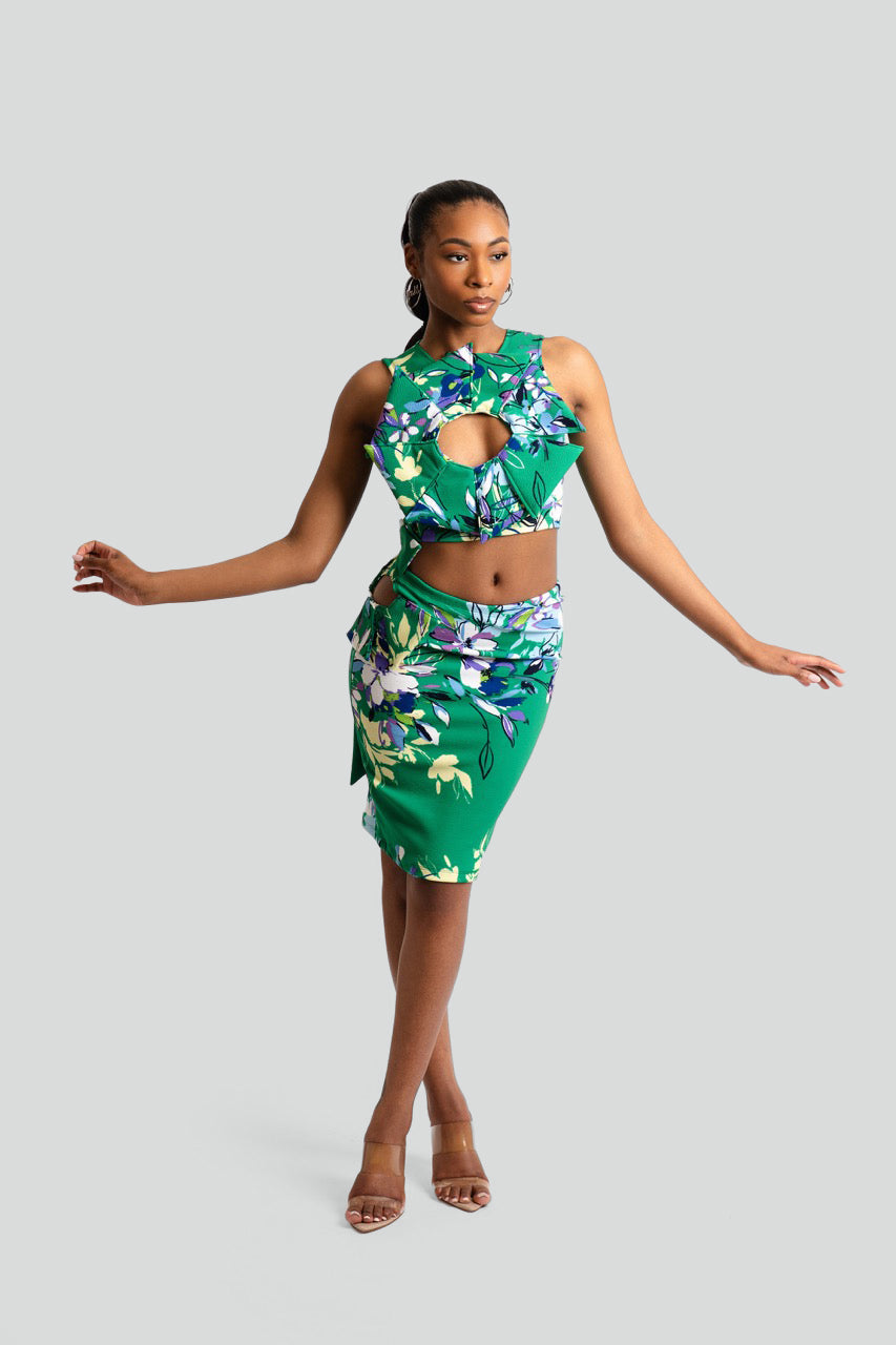 Woman wearing a green floral dress against a white background