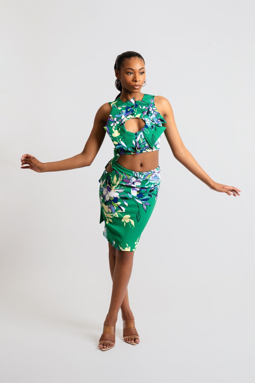 Woman wearing a green floral dress against a white background