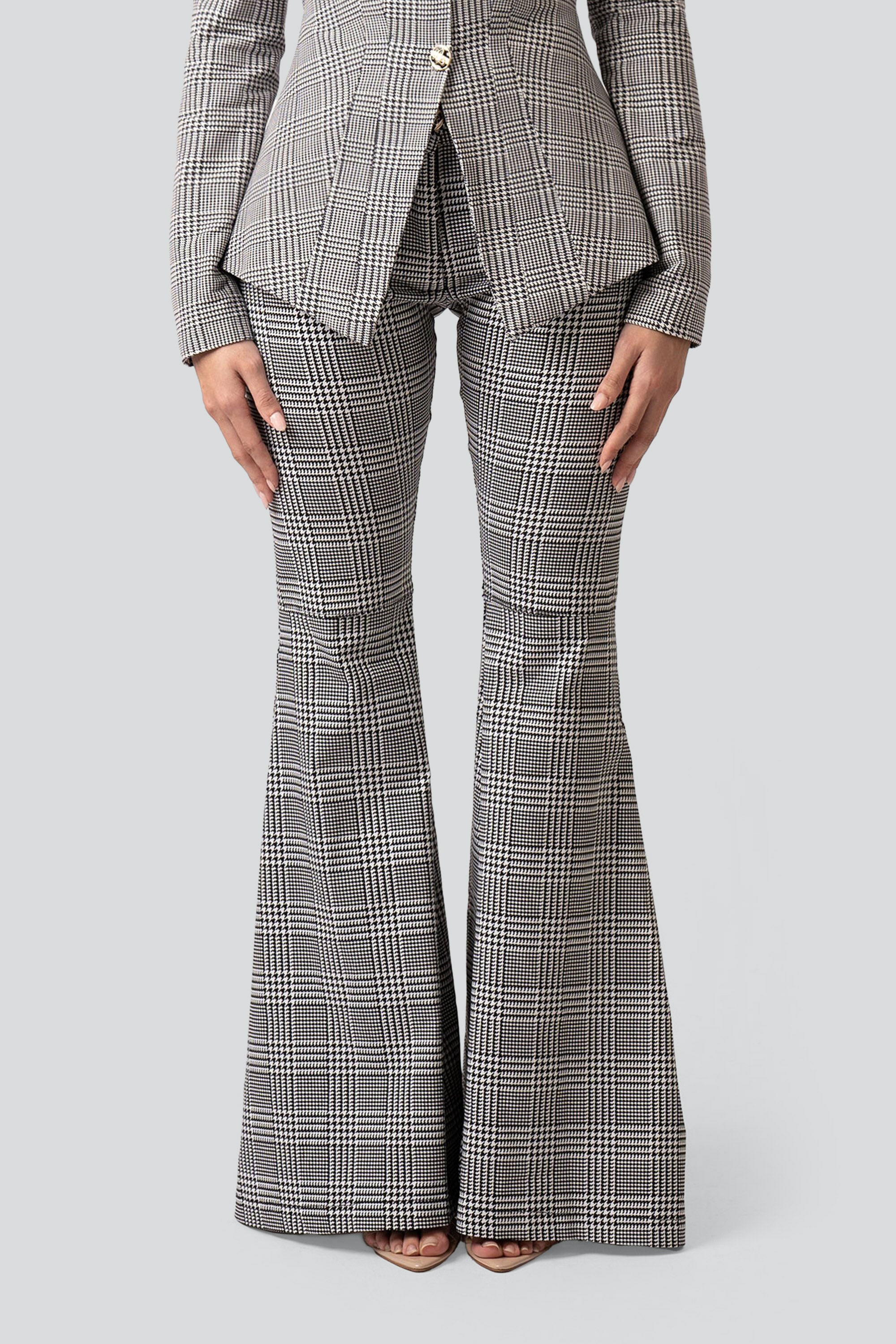 Close up of grey plaid pants with a flared bottom on a white background
