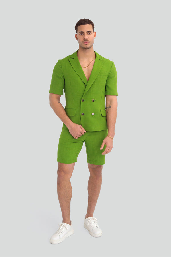 Model styling a luxury mens lime green two piece shorts set as a bold summer streetwear outfit with an architectural silhouette