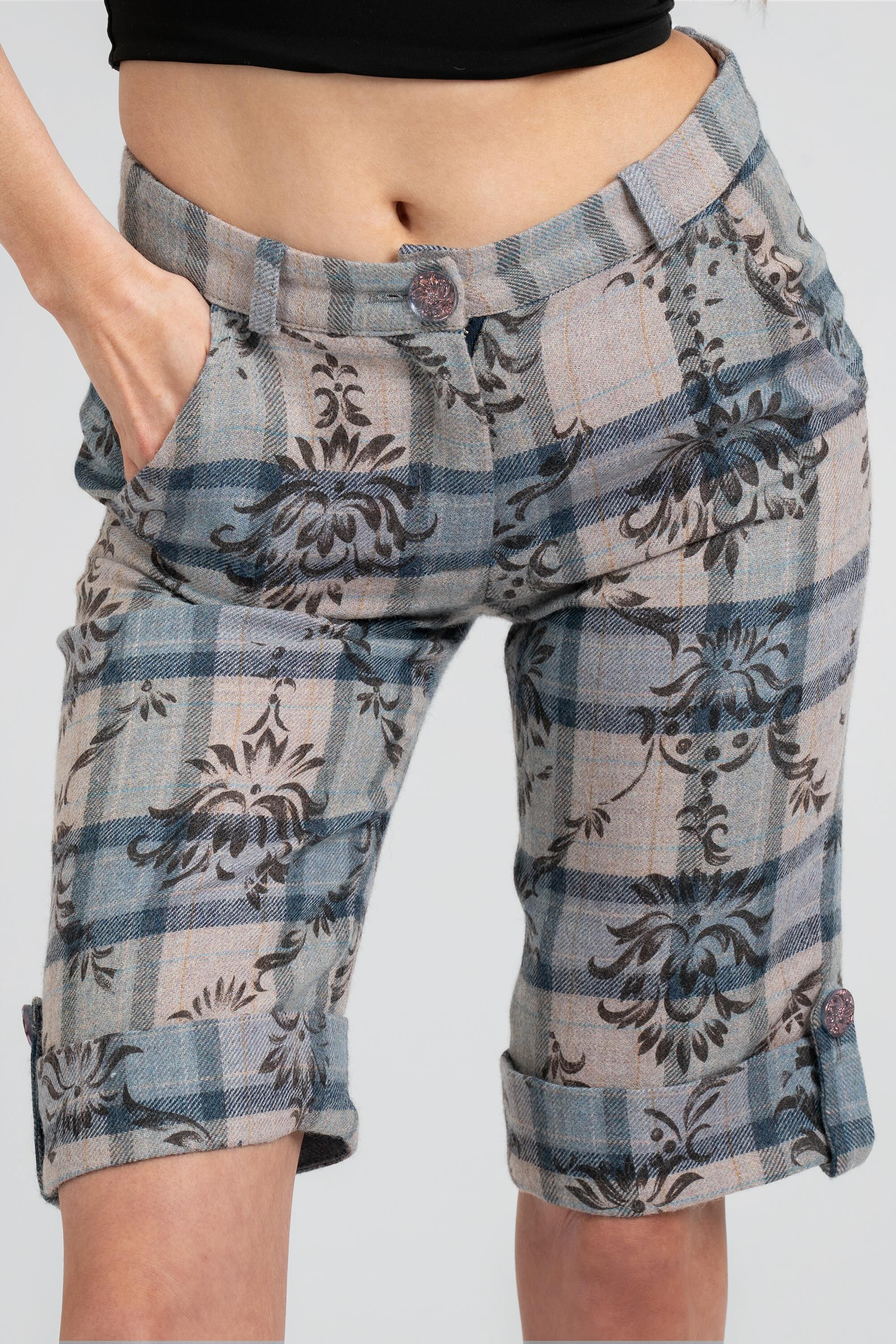 Close up of floral and plaid patterned shorts on a white background