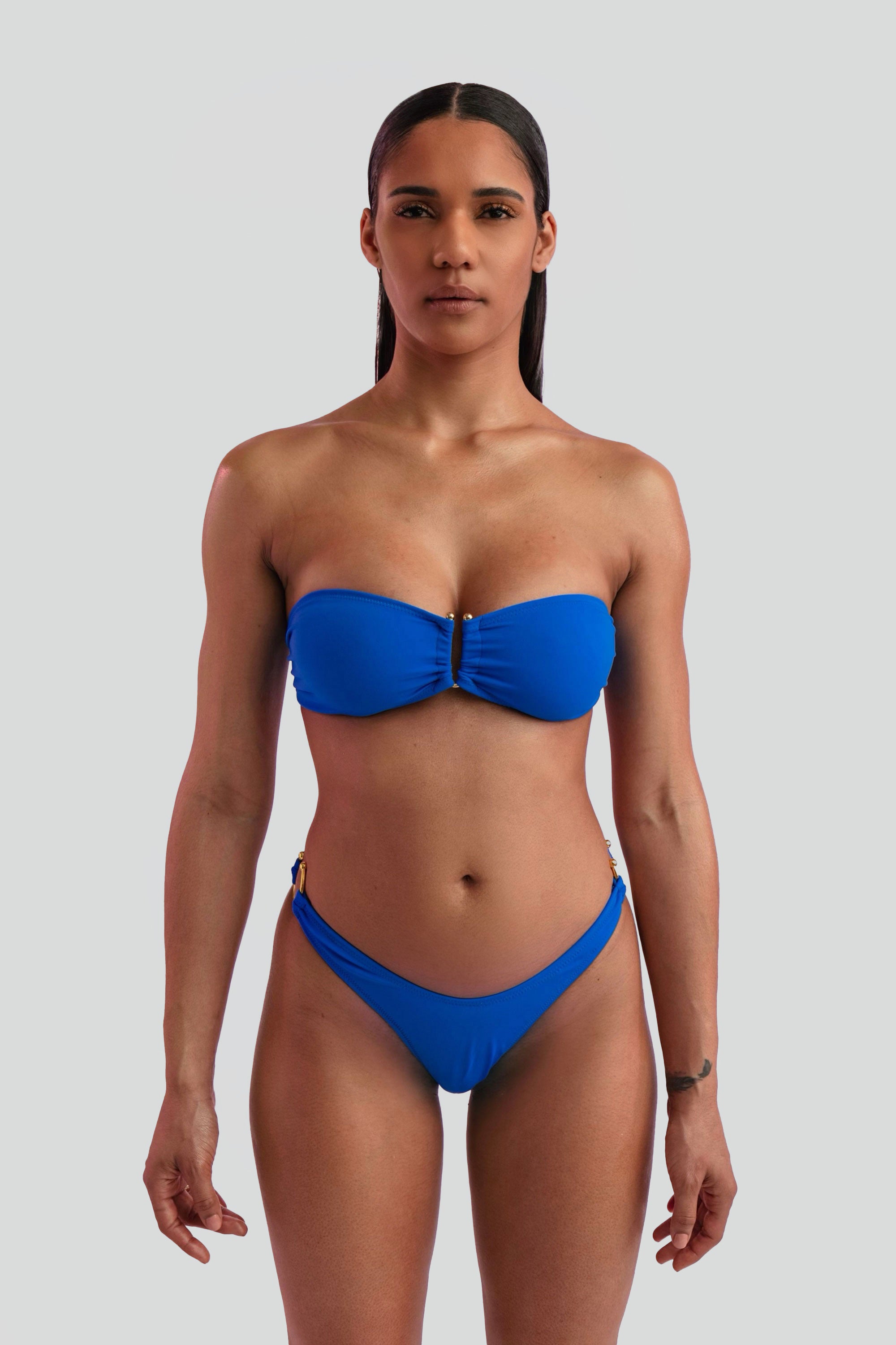 Woman wearing a blue bikini on a gray background