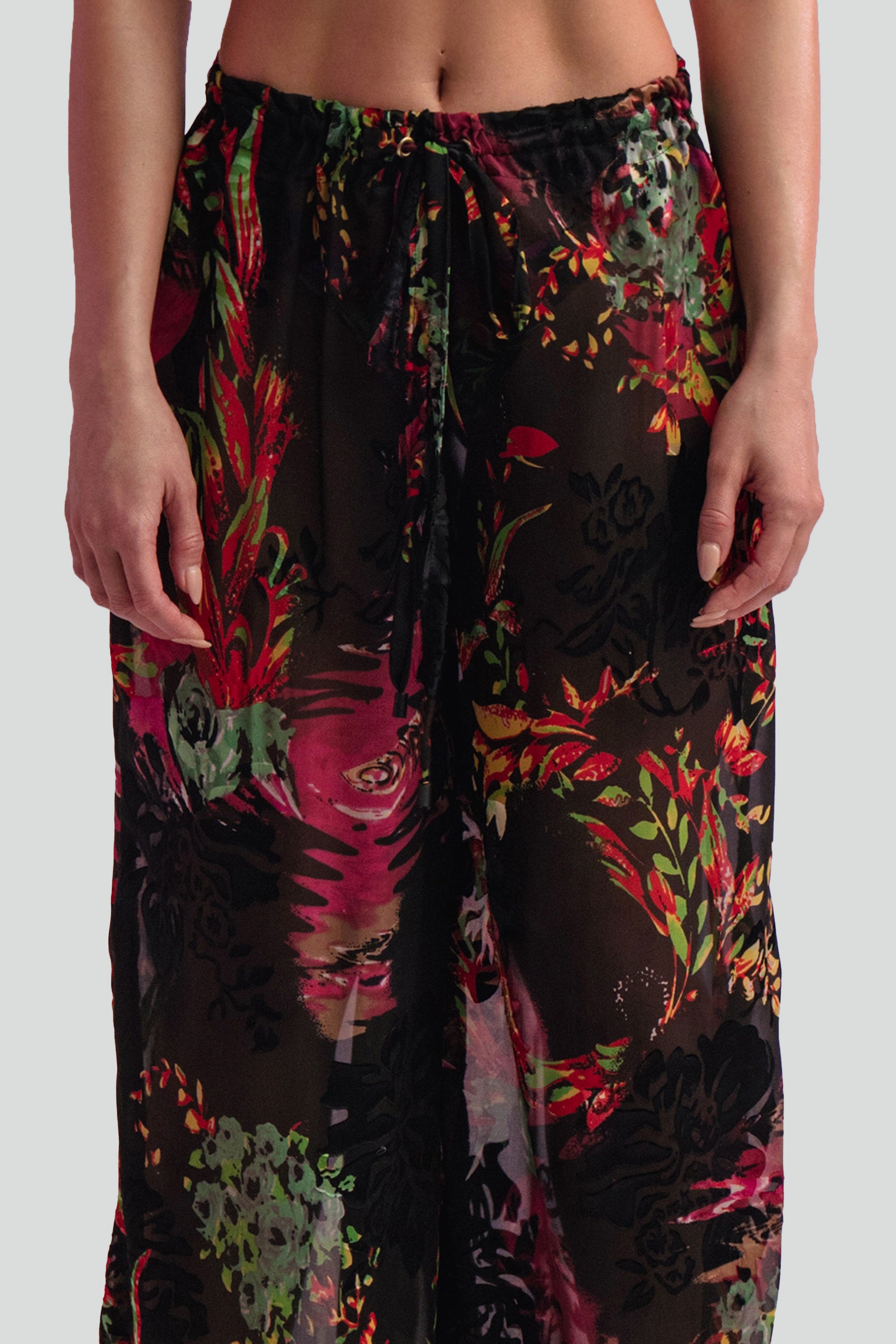 Floral-patterned pants worn by a person on a plain background