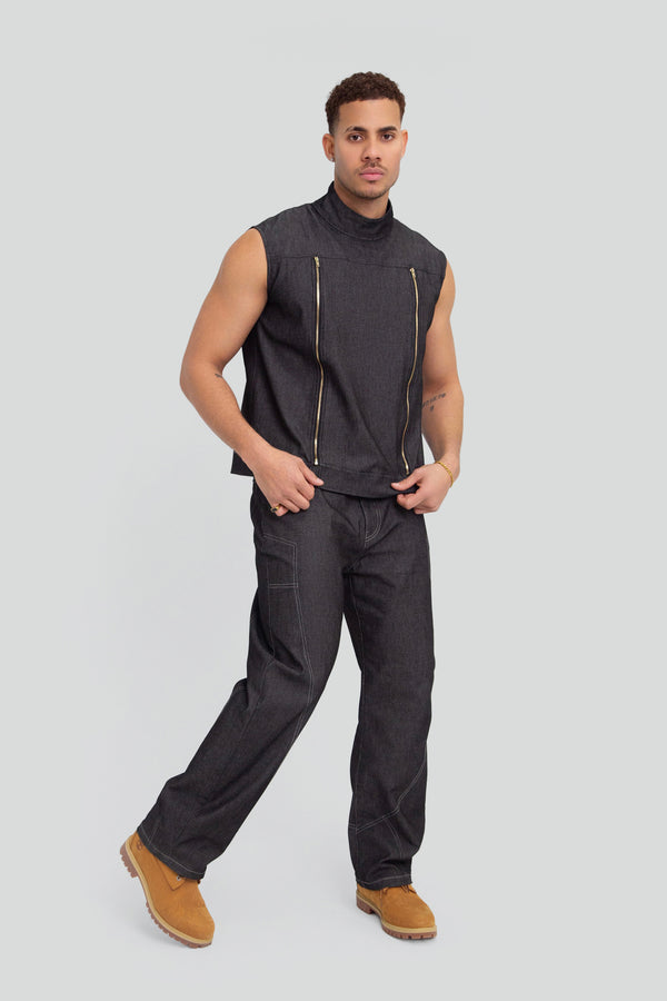 Model styling a luxury mens two piece dark denim set with a structured zip up vest and relaxed baggy fit jeans
