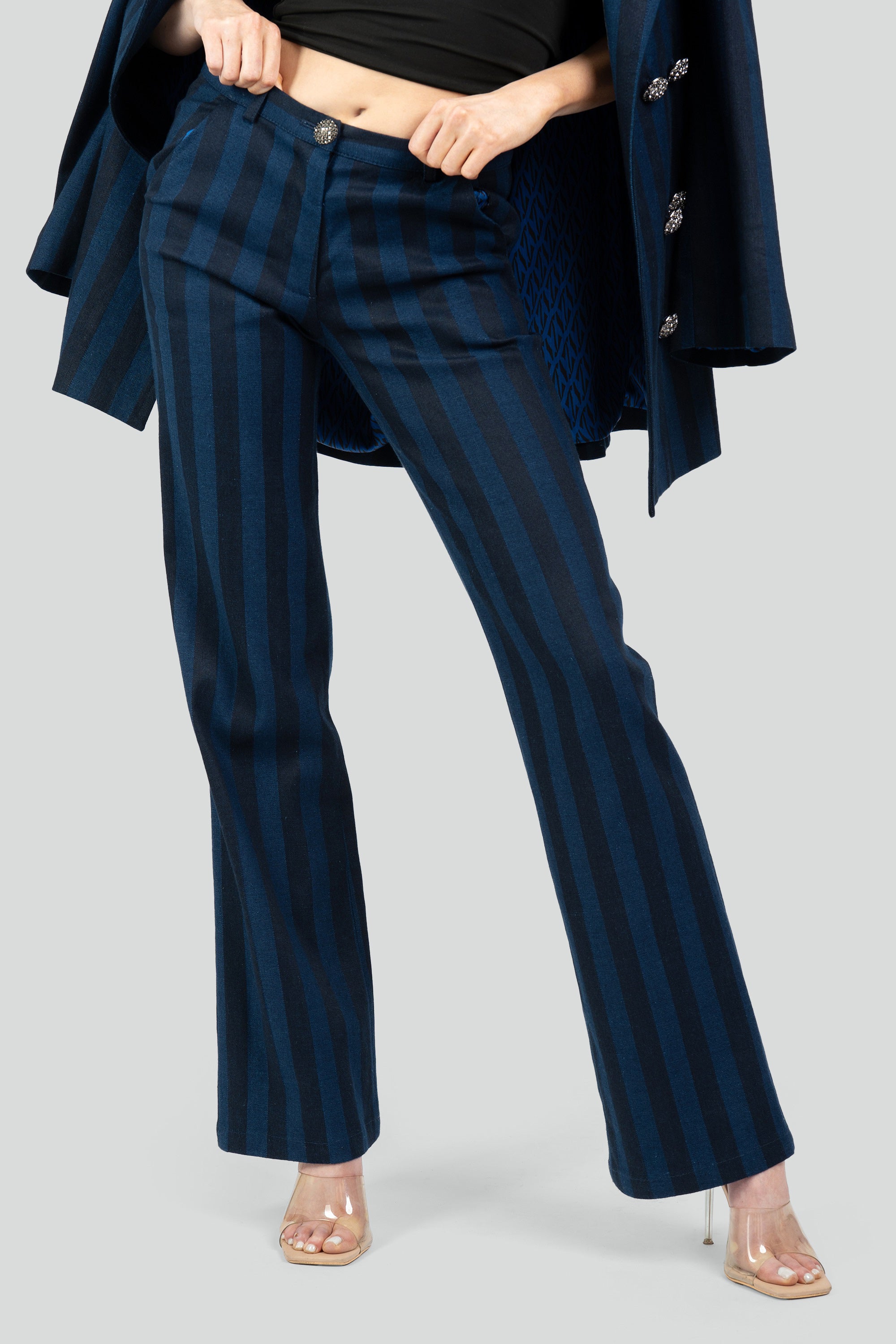 Navy striped pants worn with a matching blazer on a white background