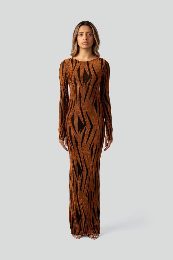 Model styling a luxury gold metallic evening gown with a bodycon stretch fit in an elegant holiday party outfit