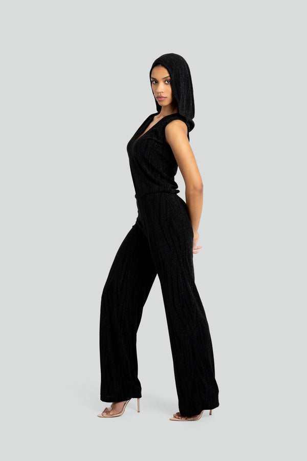 Fitted long-sleeve hooded romper in sleek black stretch fabric, featuring a sharp plunging V-neckline and a tonal horizontal geometric shimmer print