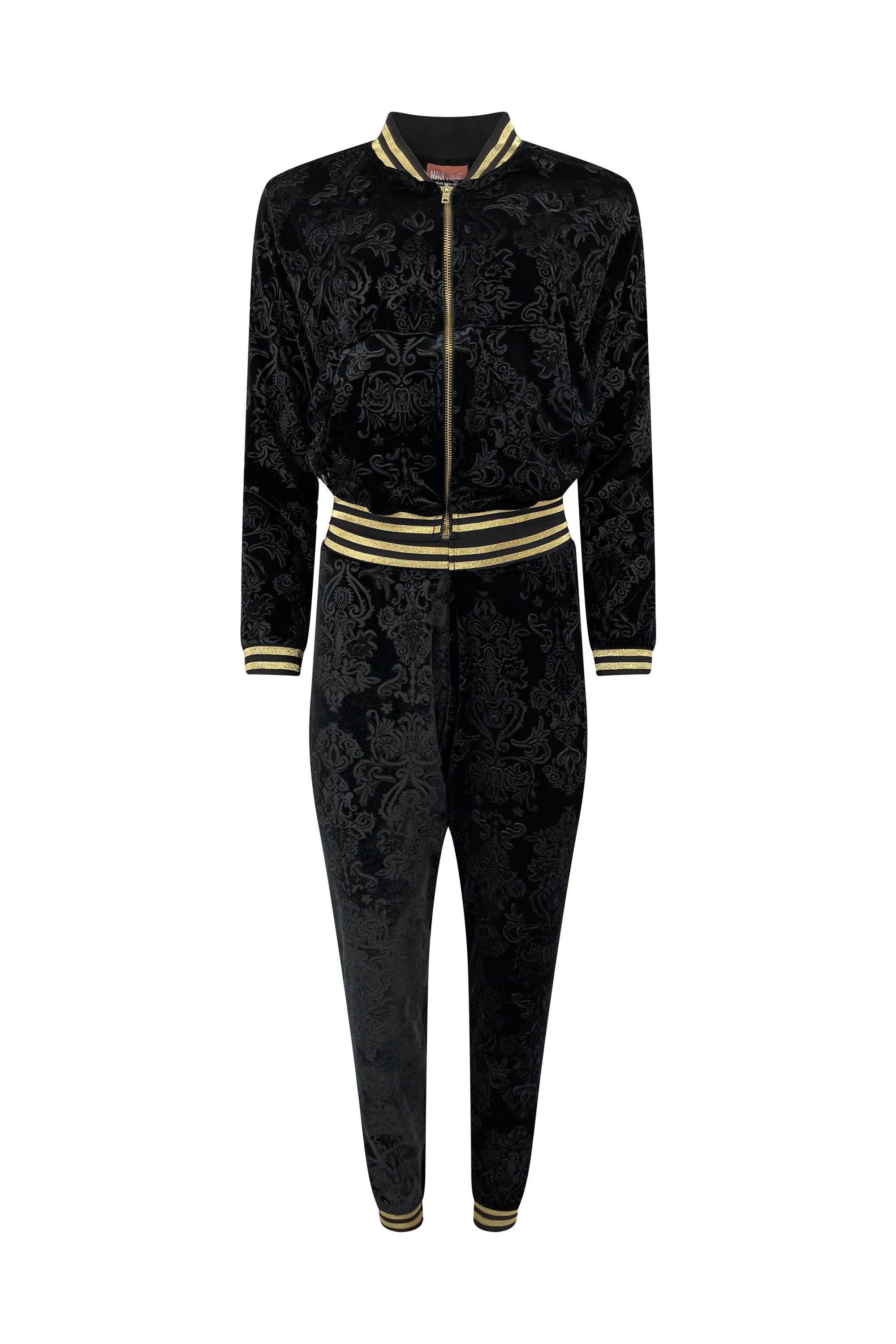 A black velour tracksuit with floral patterns and gold trim on a white background