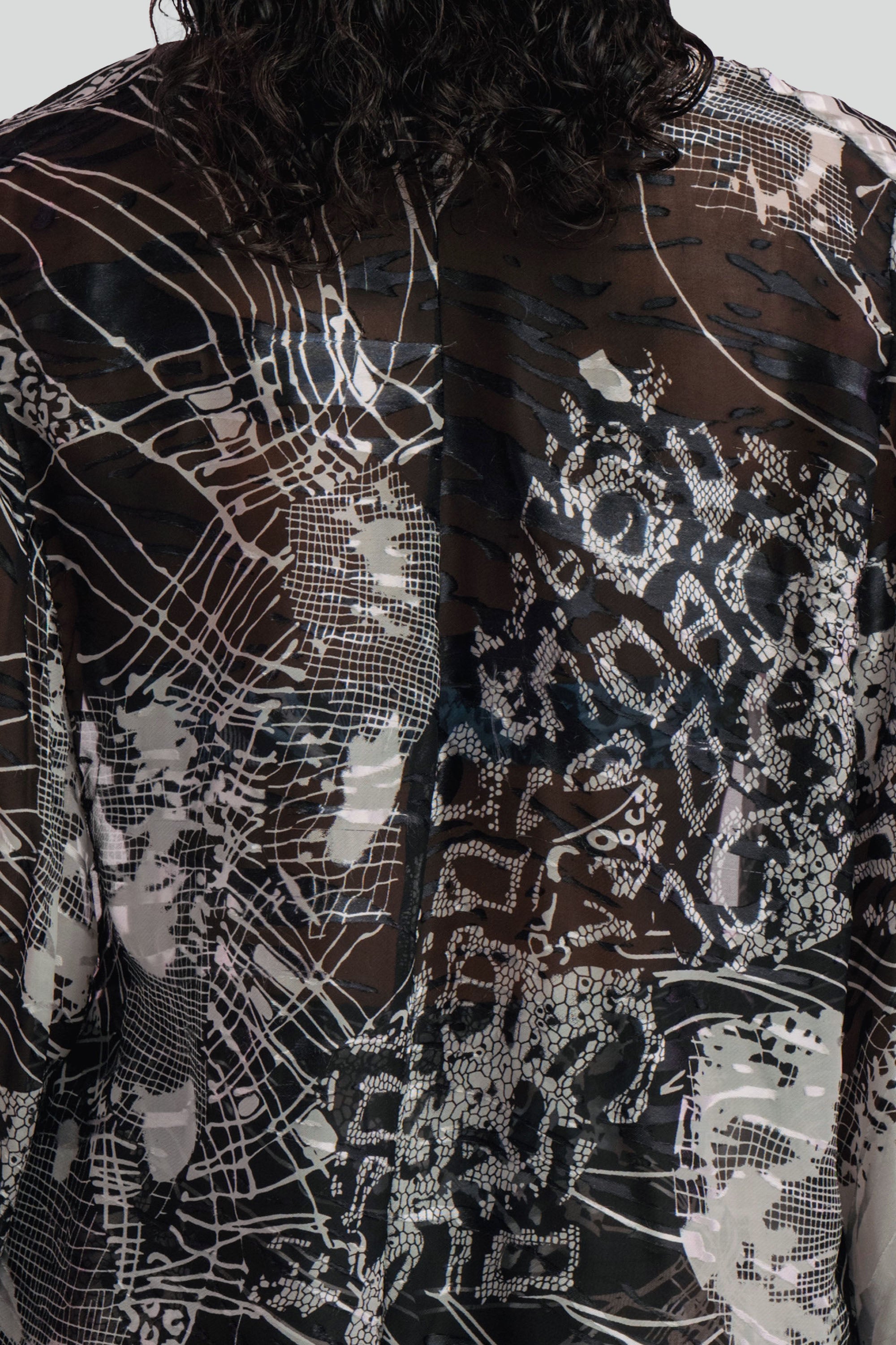 Detailed view of the black and white patterned cover up top