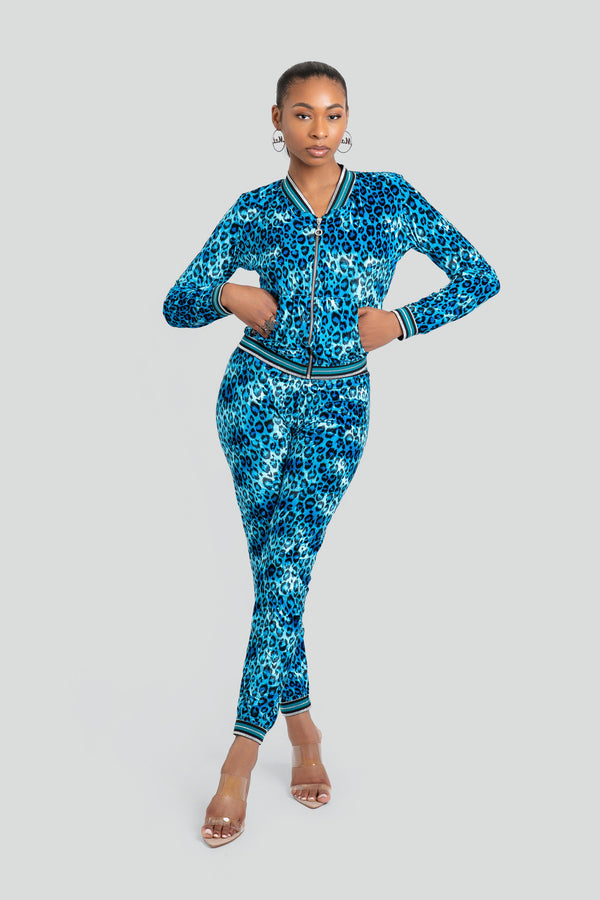High-waisted, form-fitting blue and black animal print velour jogger pants finished with tight cinched elastic ankle cuffs