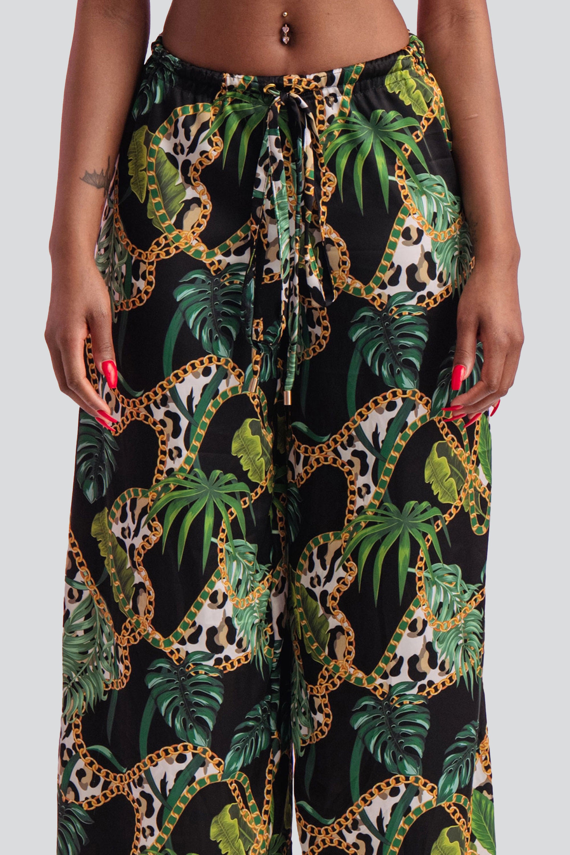 Tropical print wide leg pants on a gray background