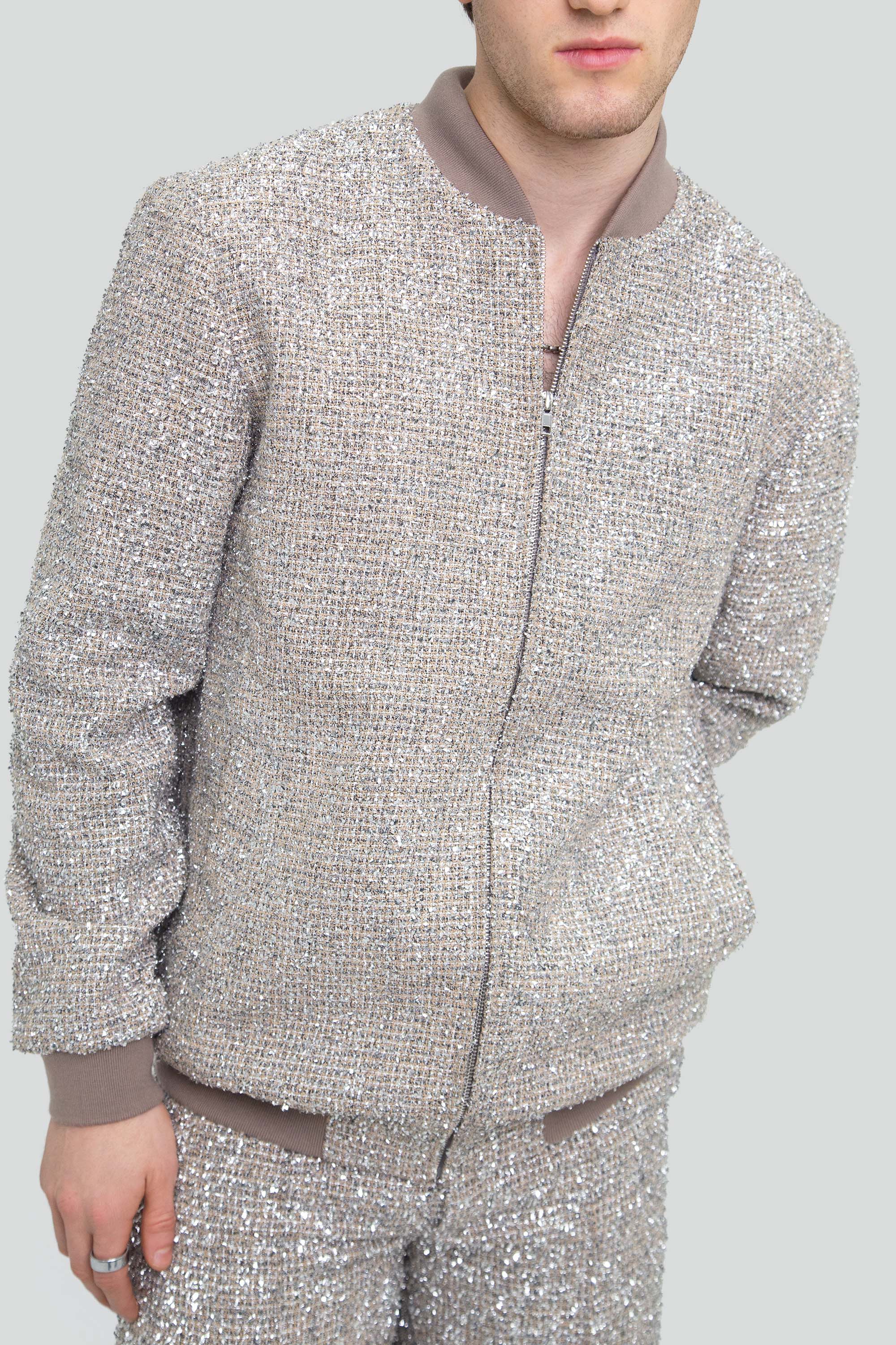 Person wearing a textured silver outfit on a plain background