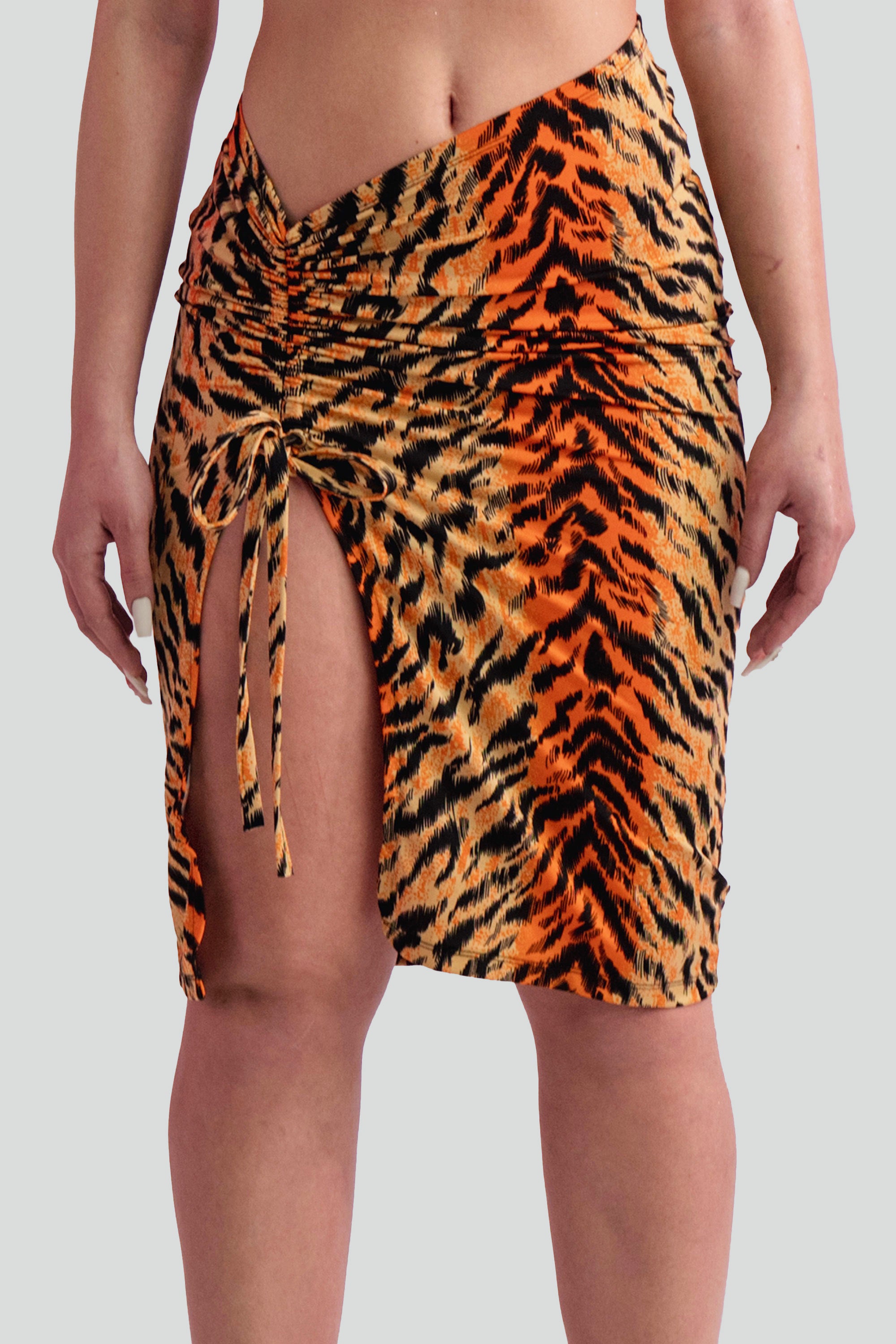 Tiger print skirt with ruched detailing against a gray background