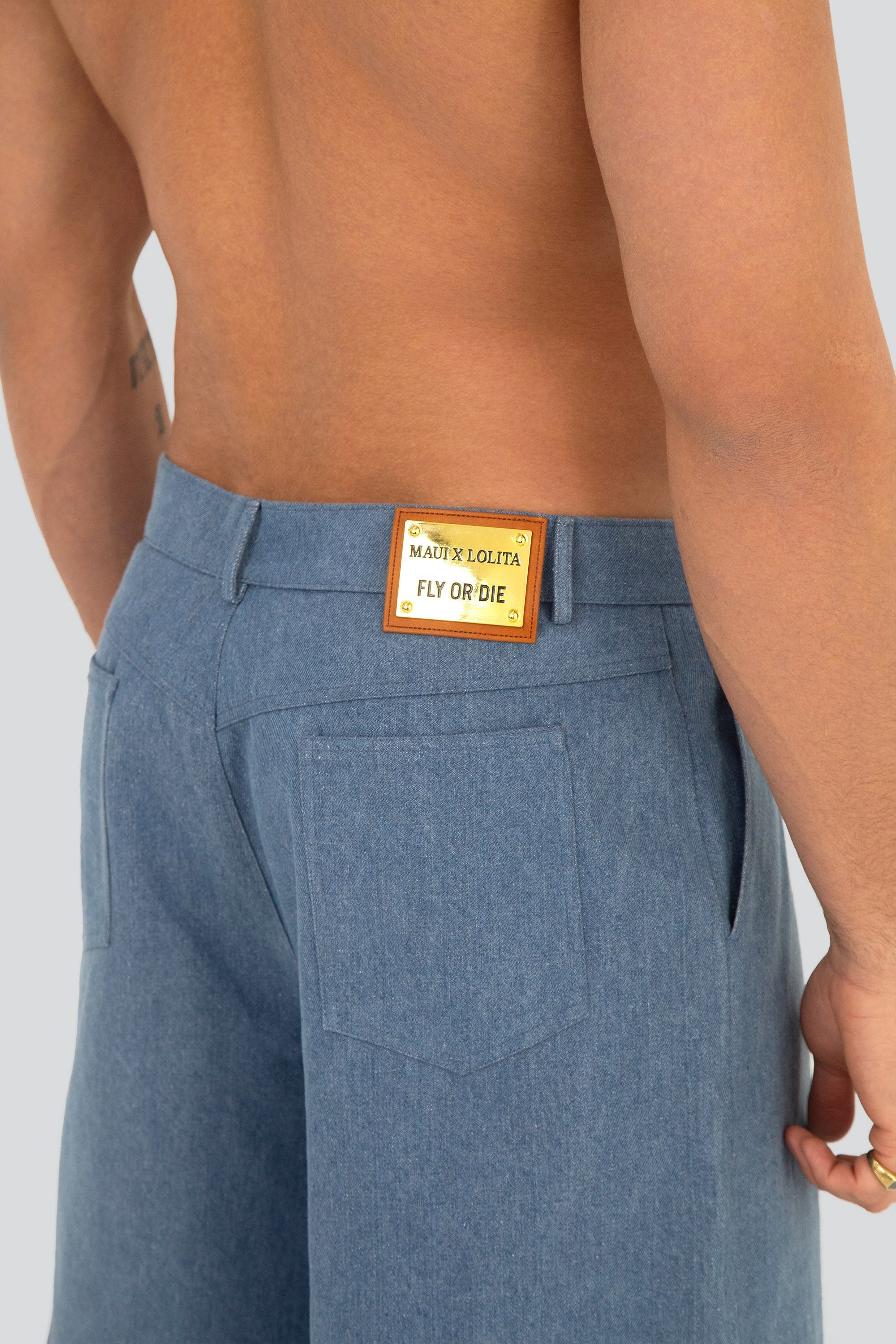 Denim shorts with a brand label on the back pocket against a plain background