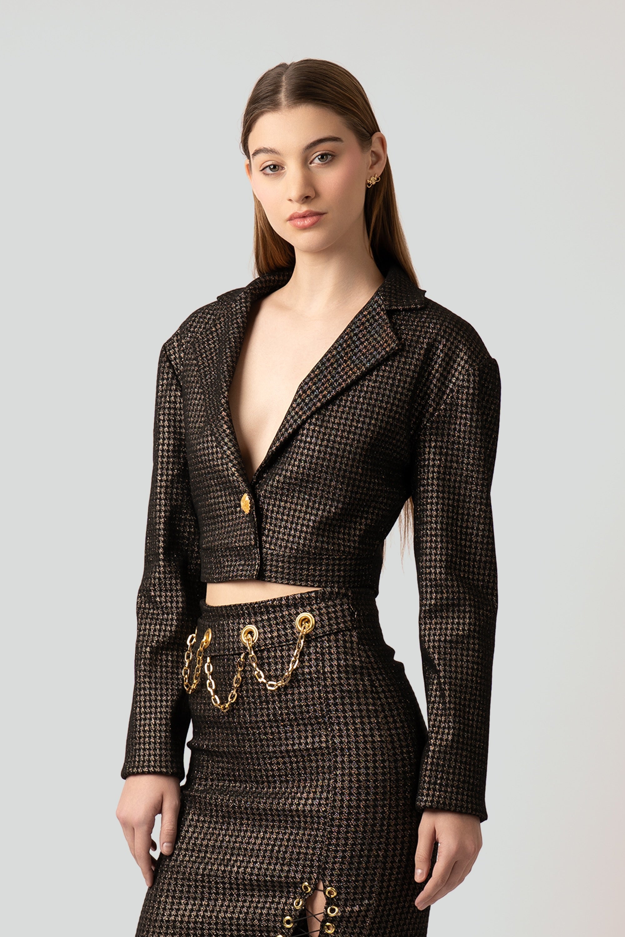 Front view of a tailored women's blazer crafted from a reflective brown and gold houndstooth grid print fabric with structured shoulders