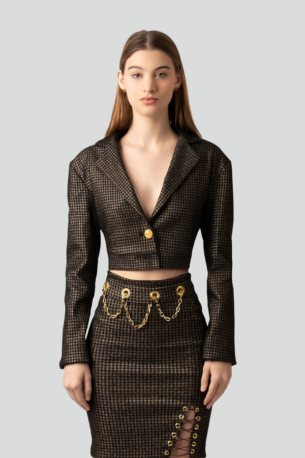 Model styling a luxury metallic grid print two piece skirt suit with gold flake buttons in a premium streetwear outfit layout