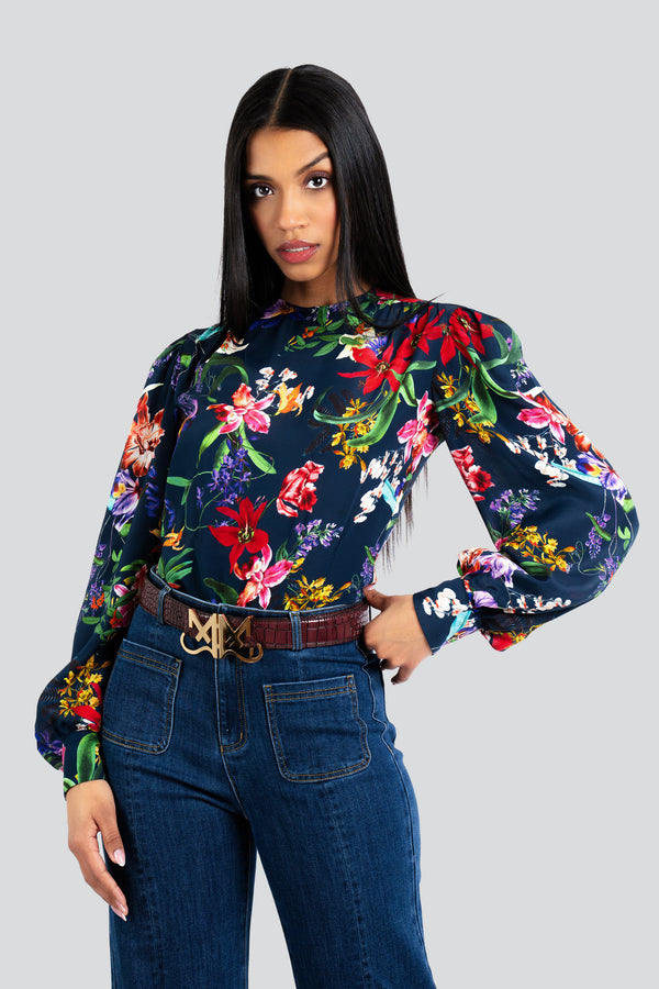 Front view of a women's long-sleeve statement blouse made of lightweight silk-viscose fabric, featuring a relaxed fluid drape and a vibrant multi-color floral print
