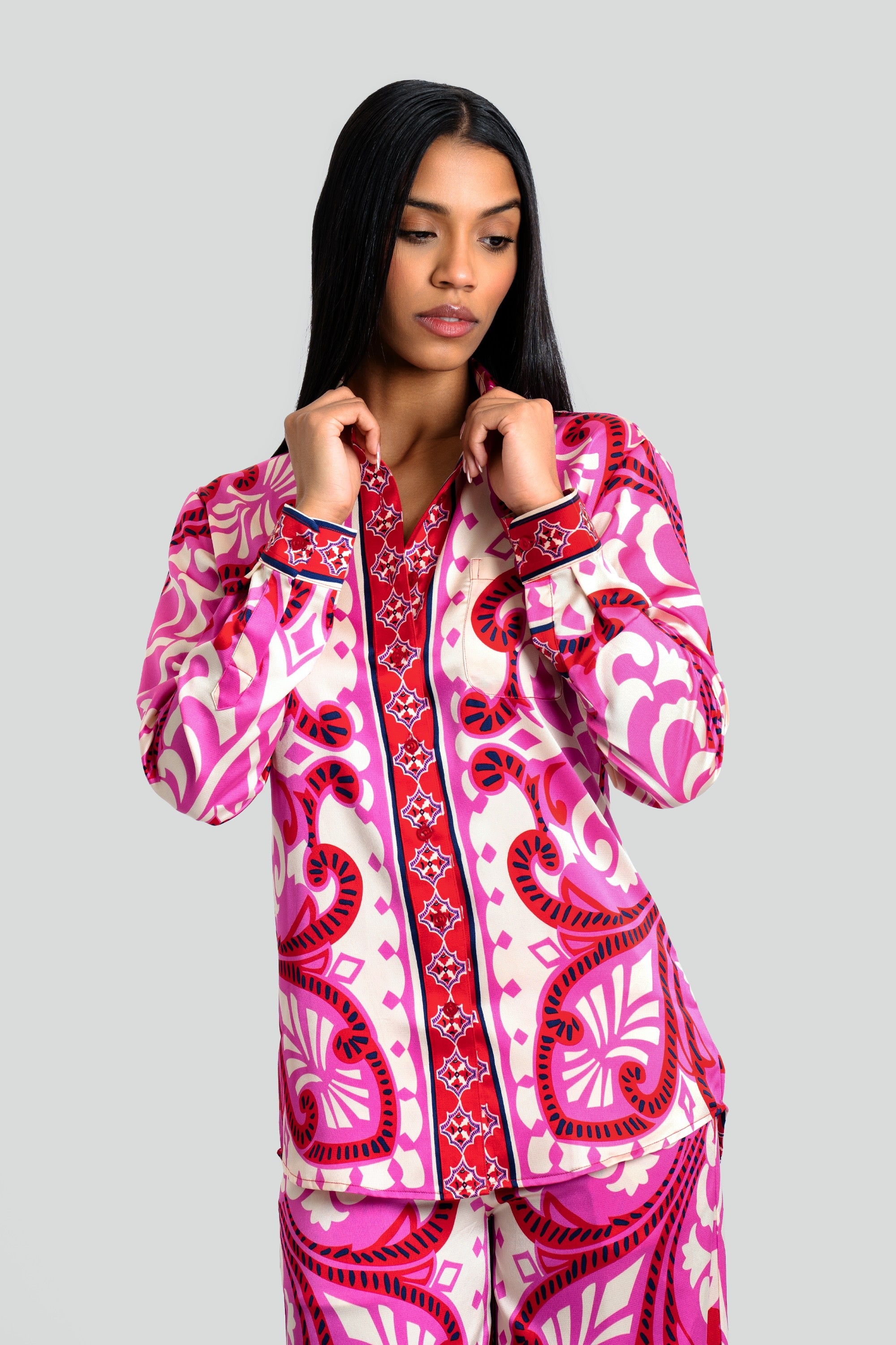Woman wearing the Maui X Lolita Yaya set, showcasing an ornate baroque print in fuchsia, crimson, and ivory on luxe poly-satin