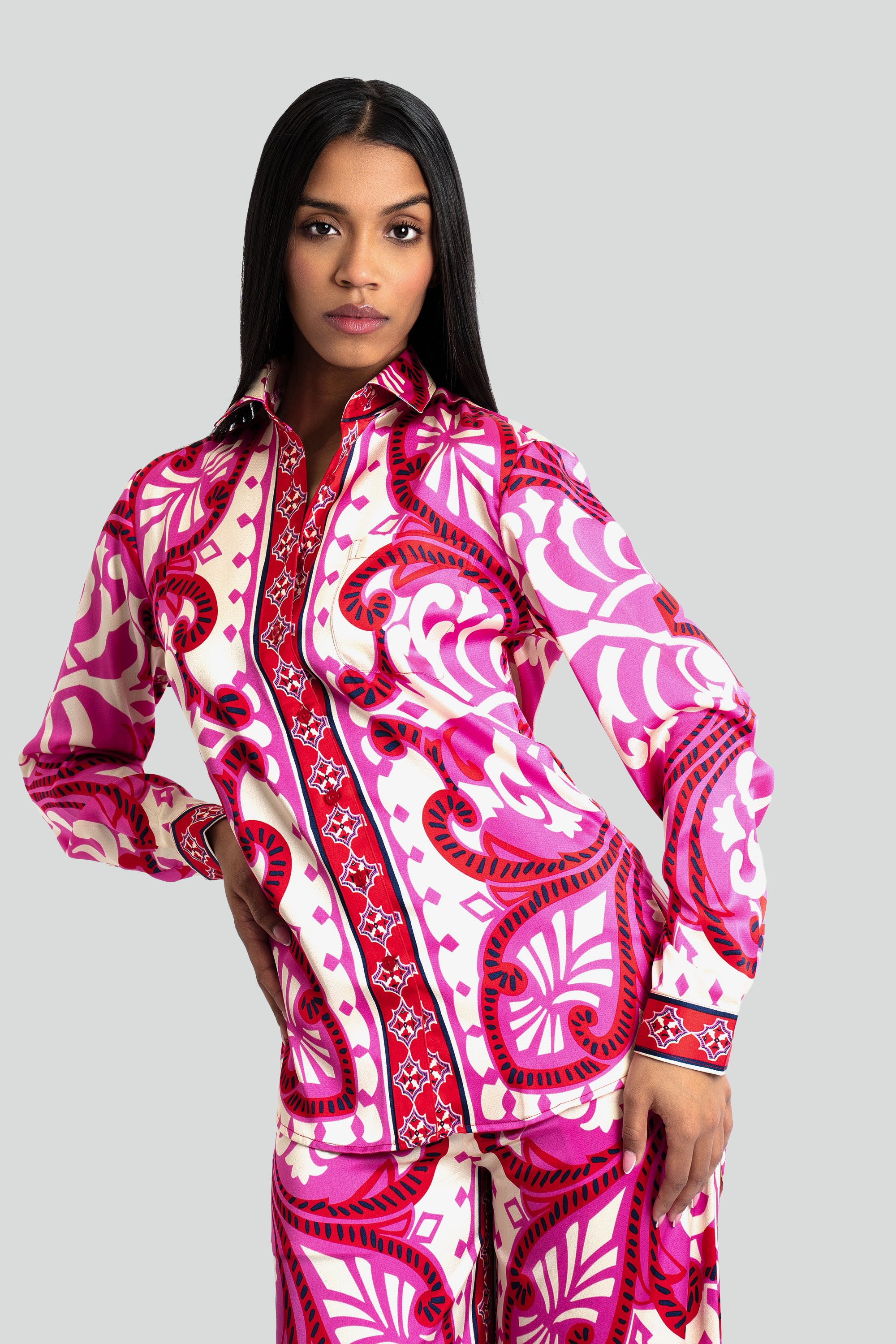Woman wearing a pink and white patterned outfit on a white background