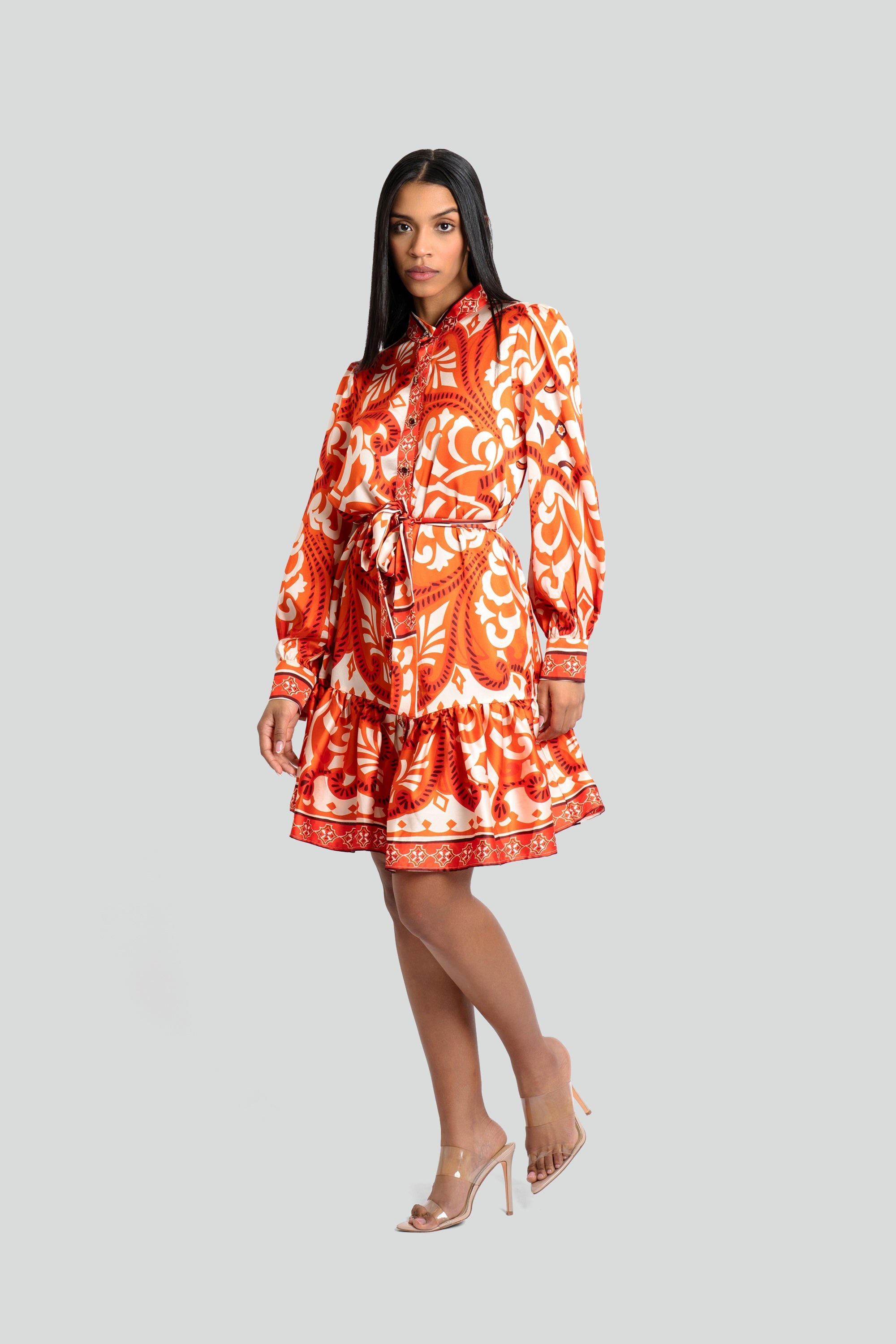 Model styling an orange baroque print satin maxi dress with a waist-cinching silhouette from Maui X Lolita
