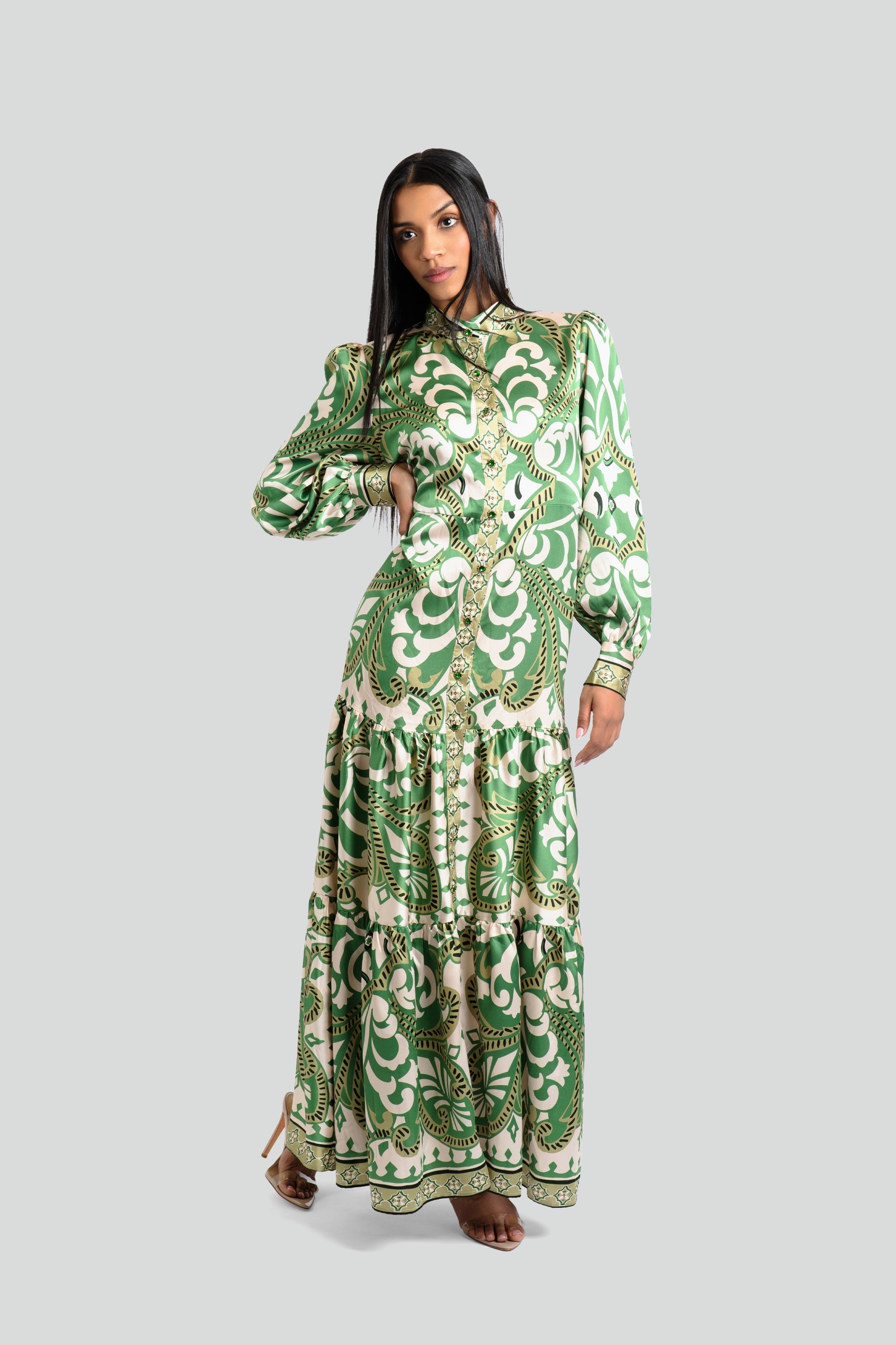 Model styling a jewel-toned green and cream baroque print designer maxi dress with a flowing silhouette by Maui X Lolita