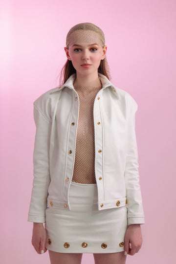 white leather jacket with gold grommets and matching skirt