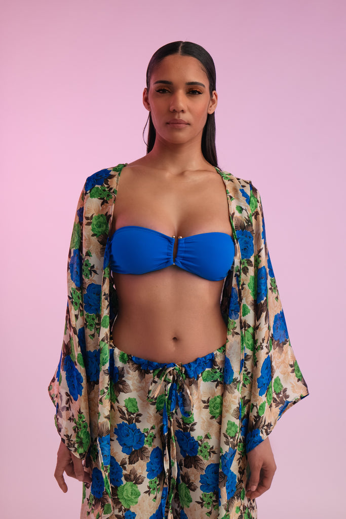 Blue bikini top under matching floral print coverup pants and top